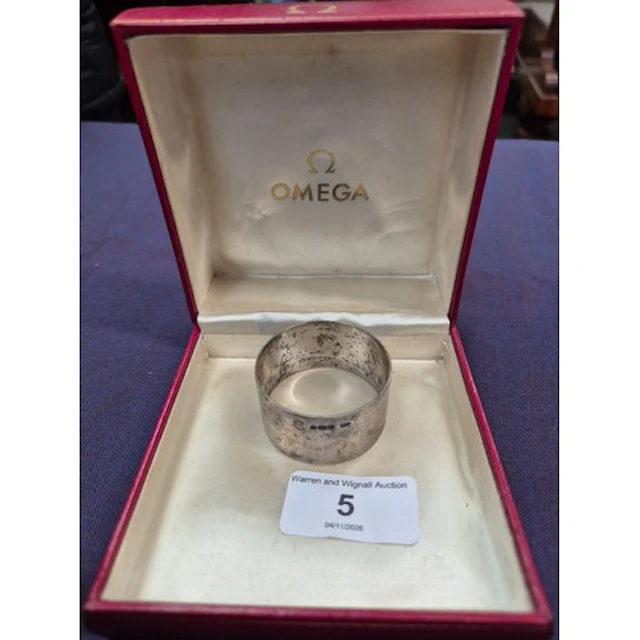 An Omega watch box and a hallmarked silver serviette ring.