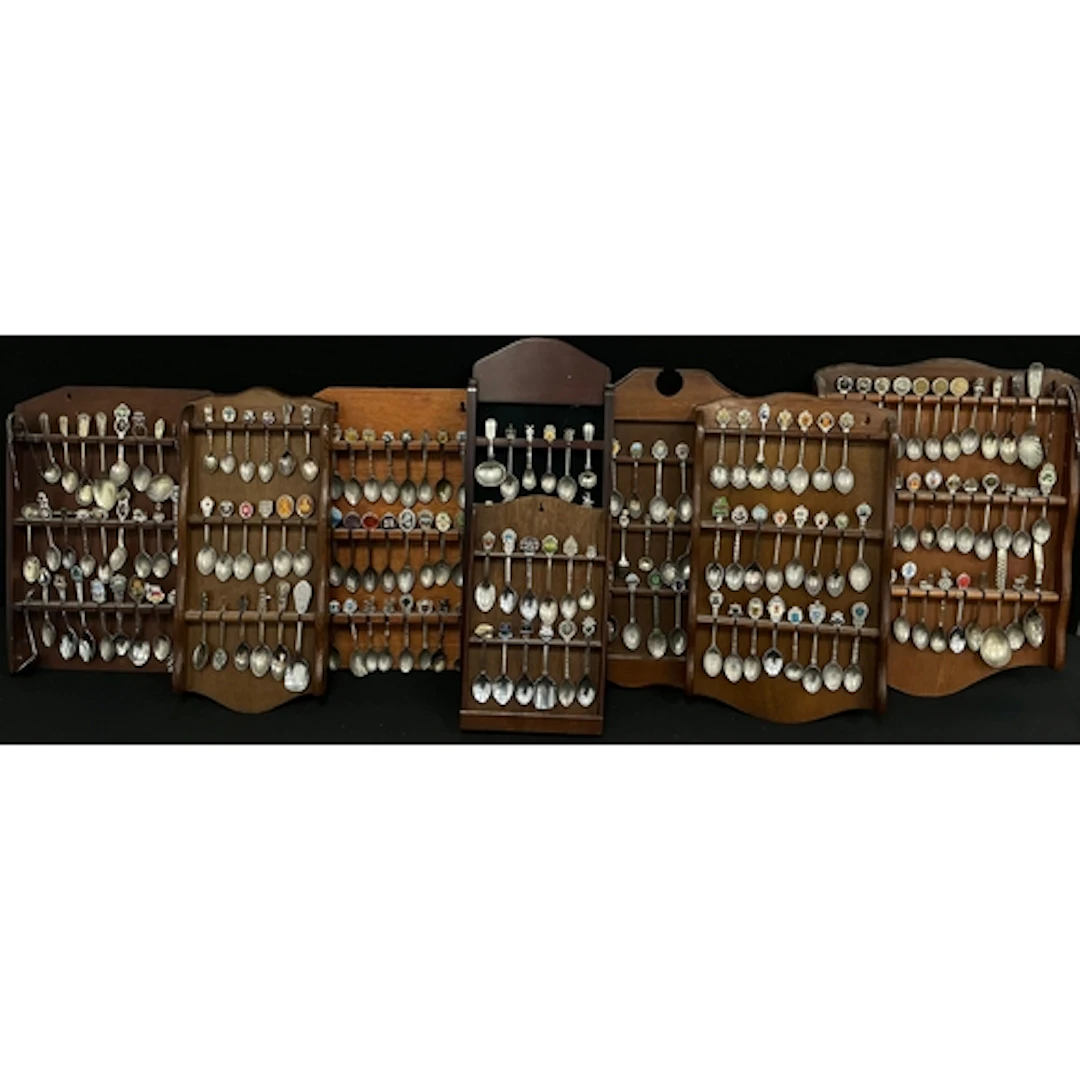 A large collection of silver plated souvenir spoons decorate...