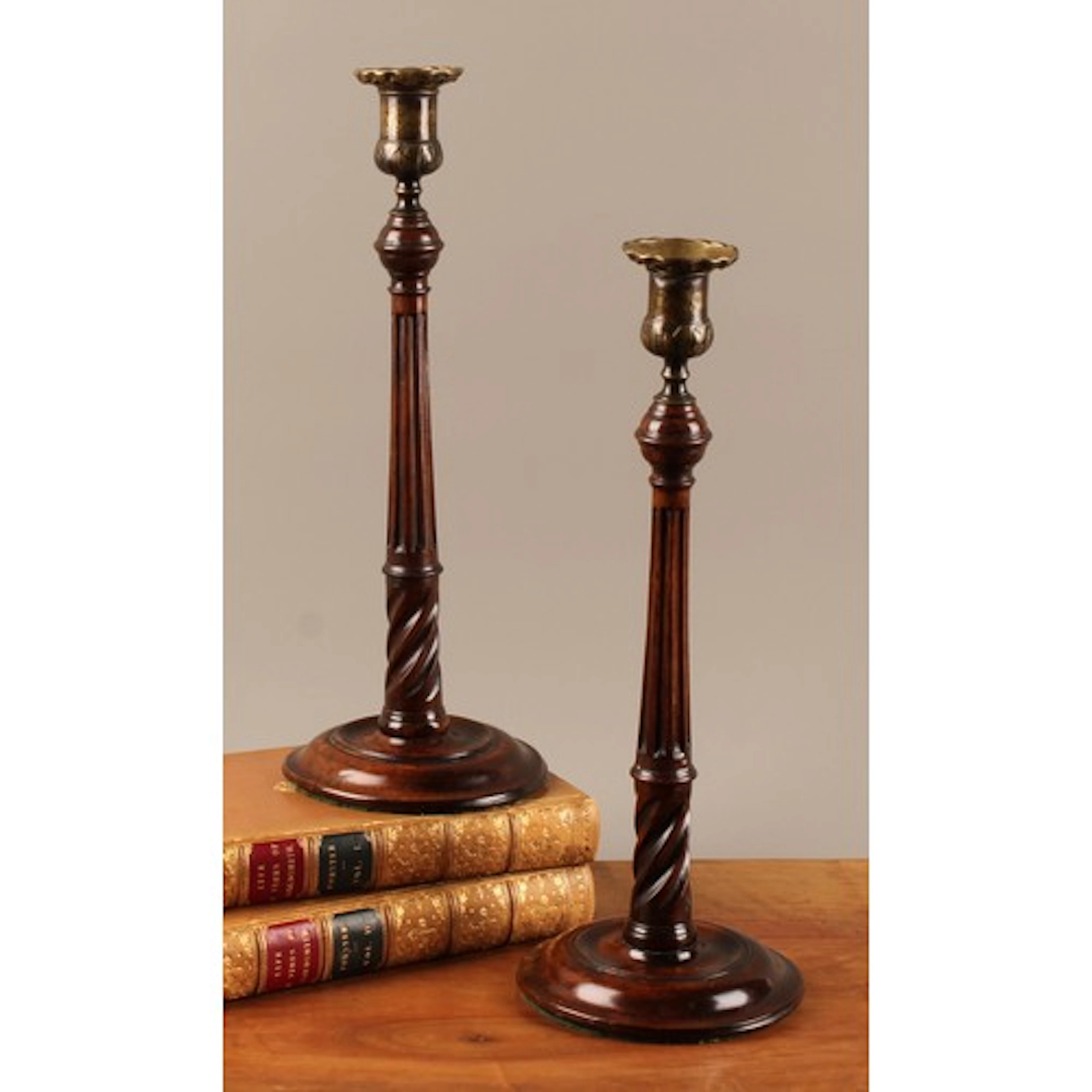 A pair of George III mahogany and brass mounted candlesticks...