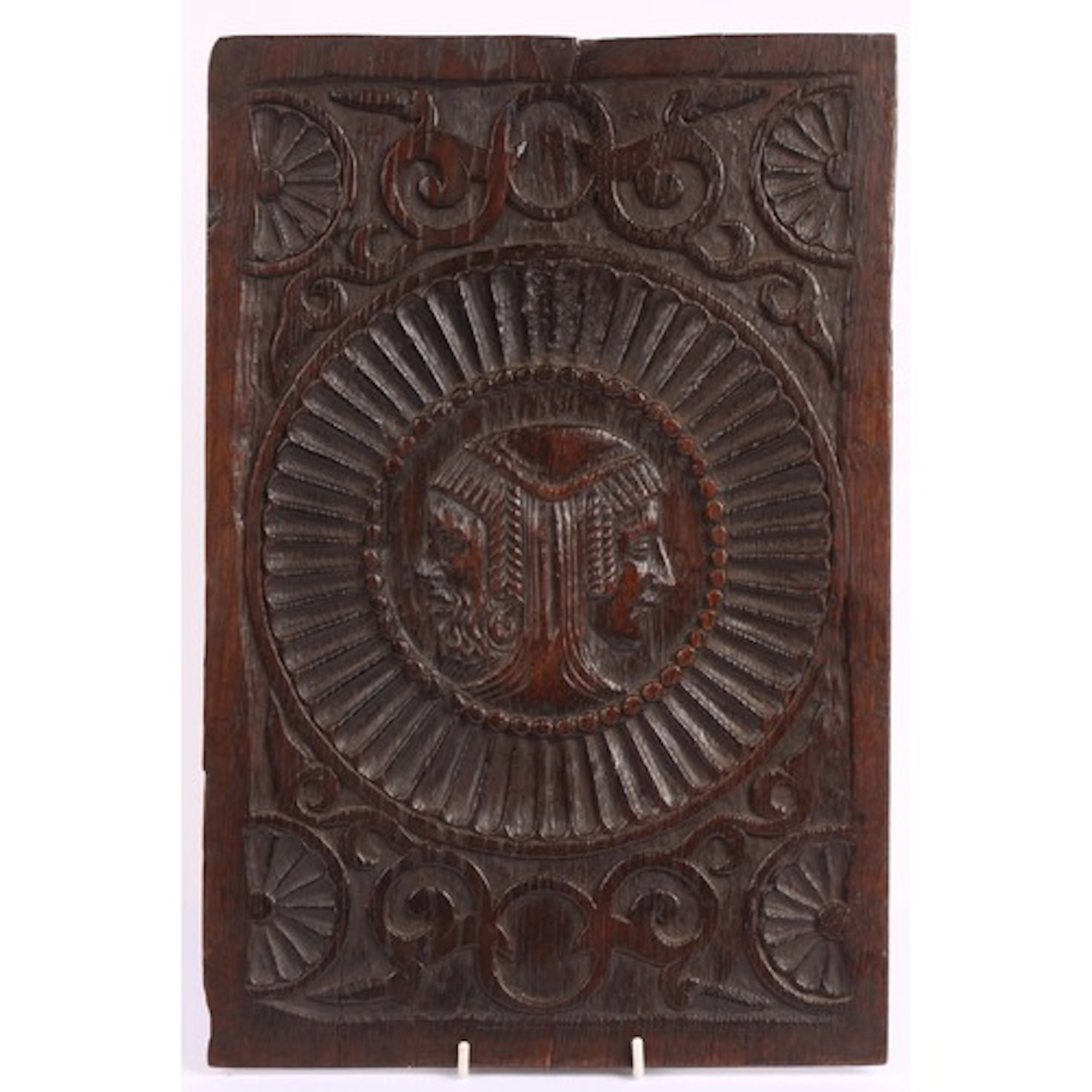 An early 17th century oak Romayne panel, carved with a wedde...