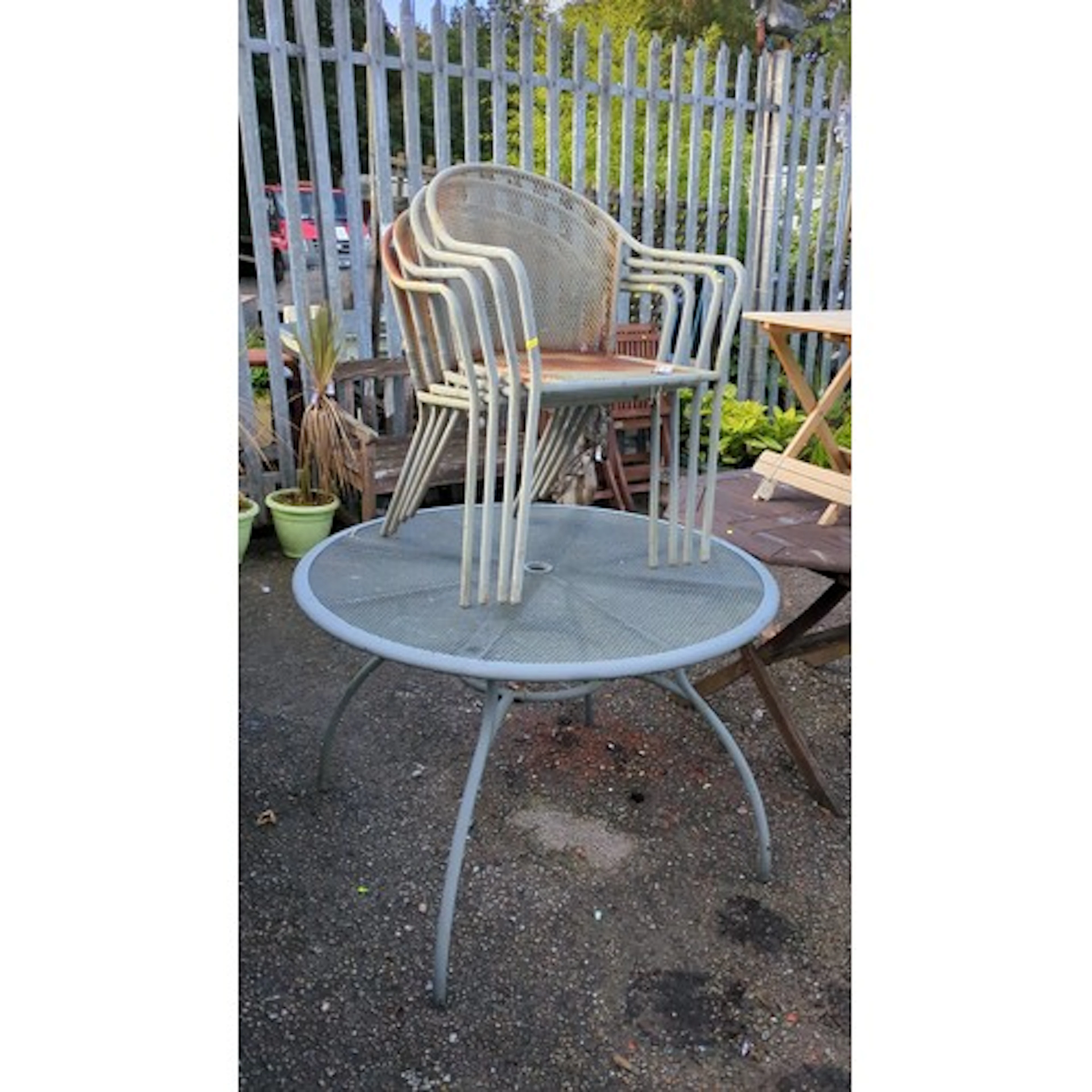 A set of metal garden furniture comprising a circular expand...