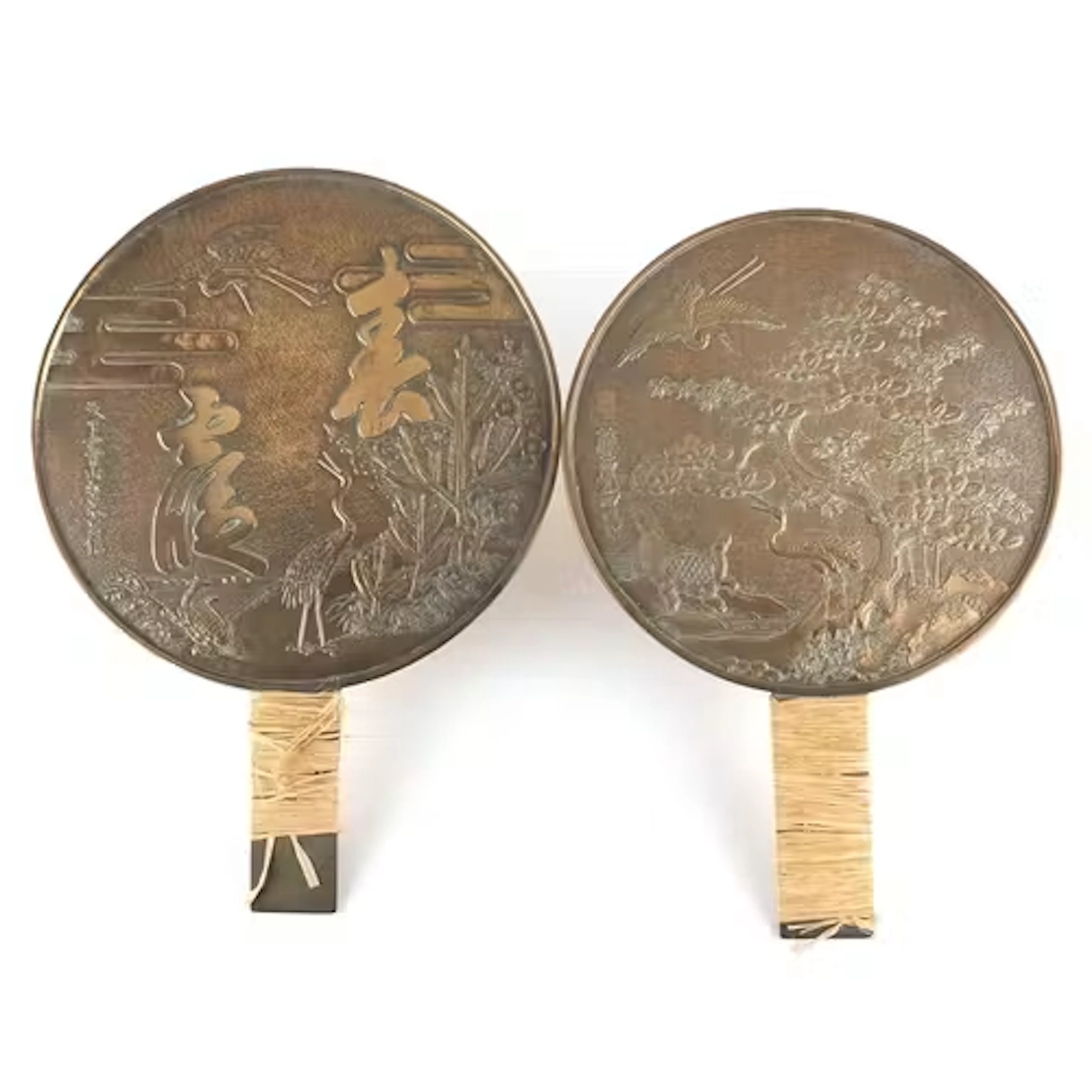 Two Japanese bronze hand mirrors cast with cranes, flowers a...