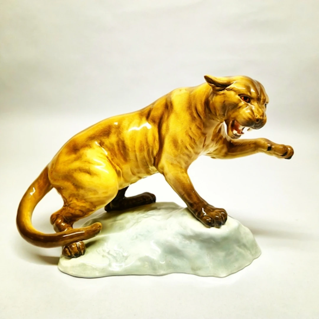 Beswick figure of a puma, glazed in brown with left paw rais...
