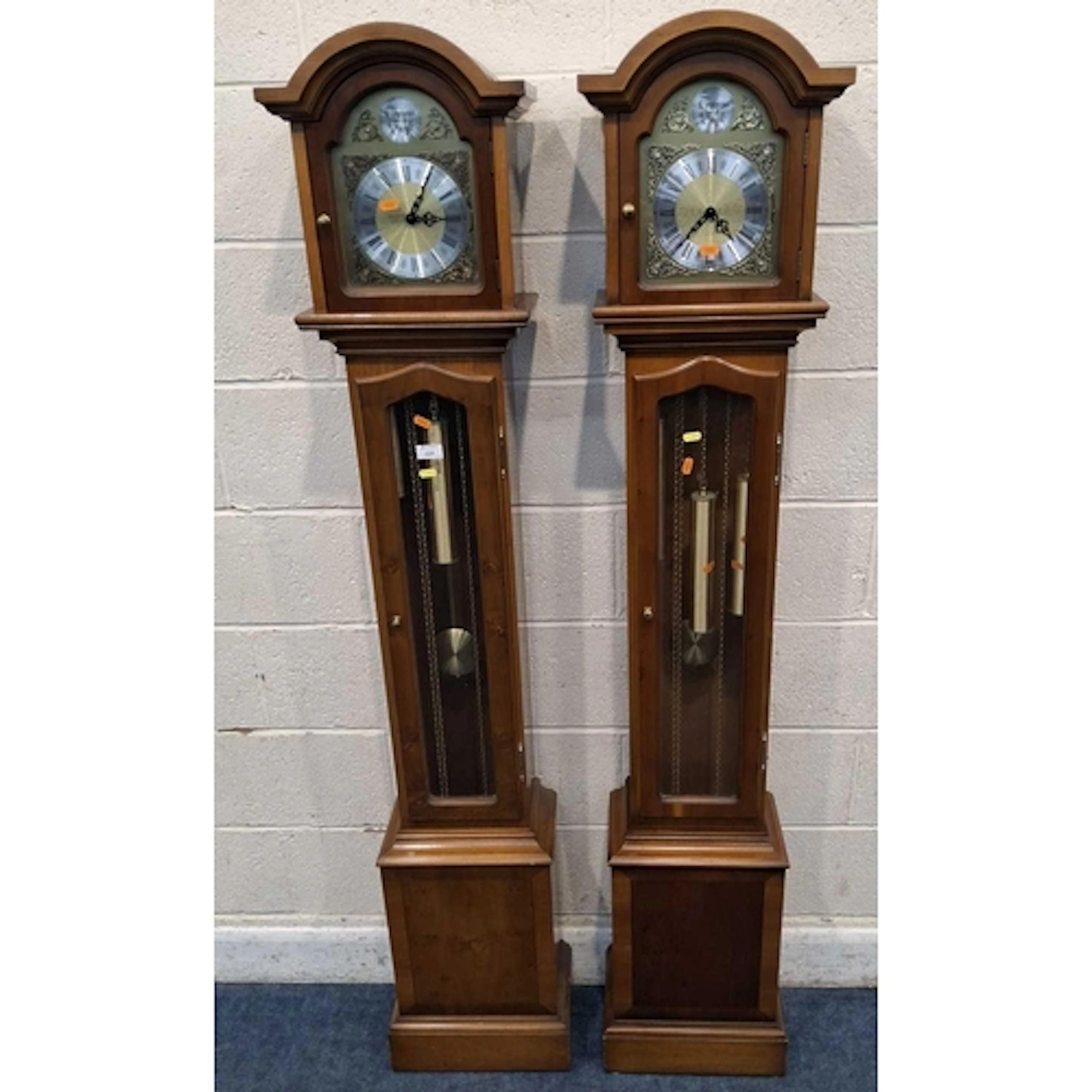 A PAIR OF TEMPUS FUGIT YEW WOOD CLOCKS, with an arched top, ...