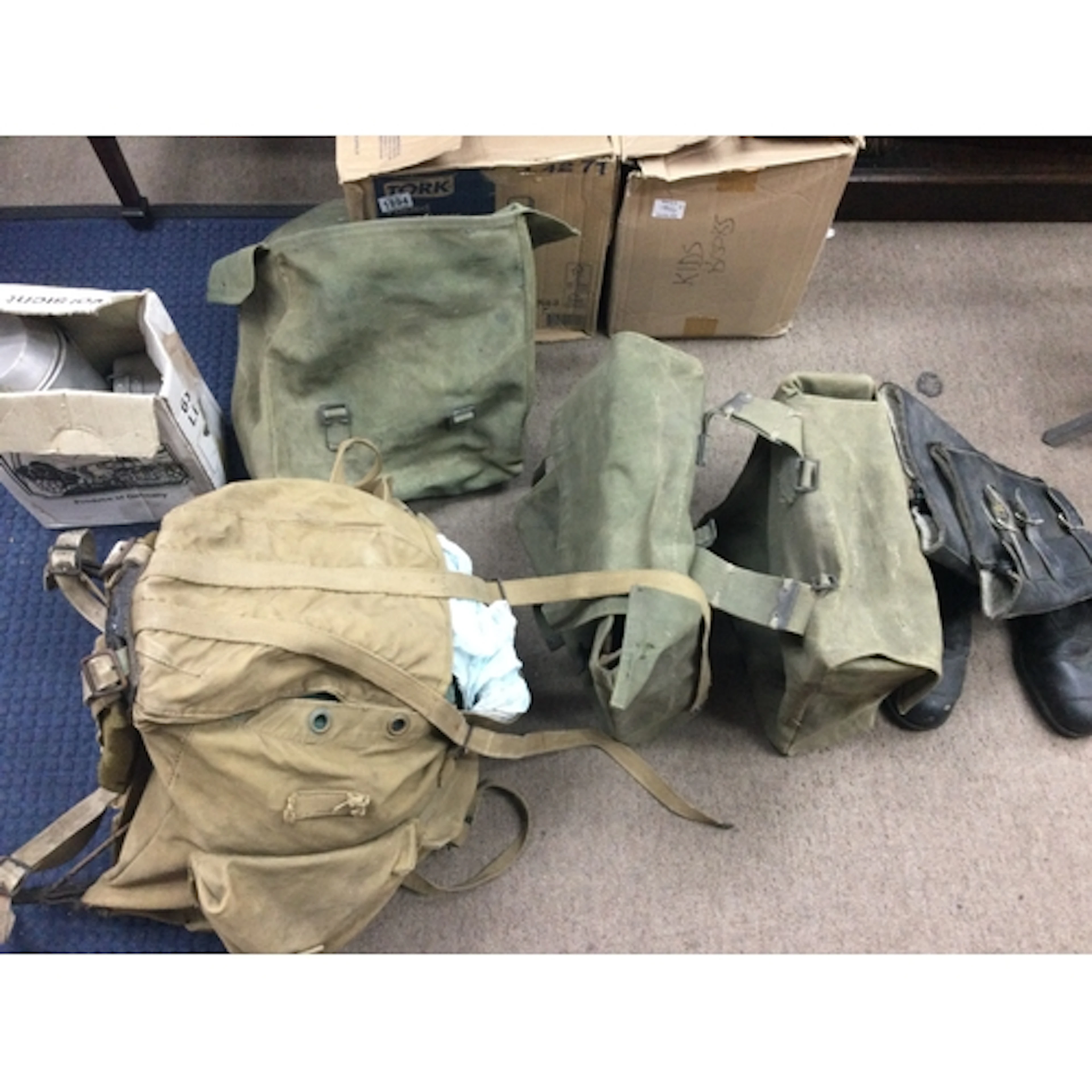 Collection of military gear and biker boots and and panniers