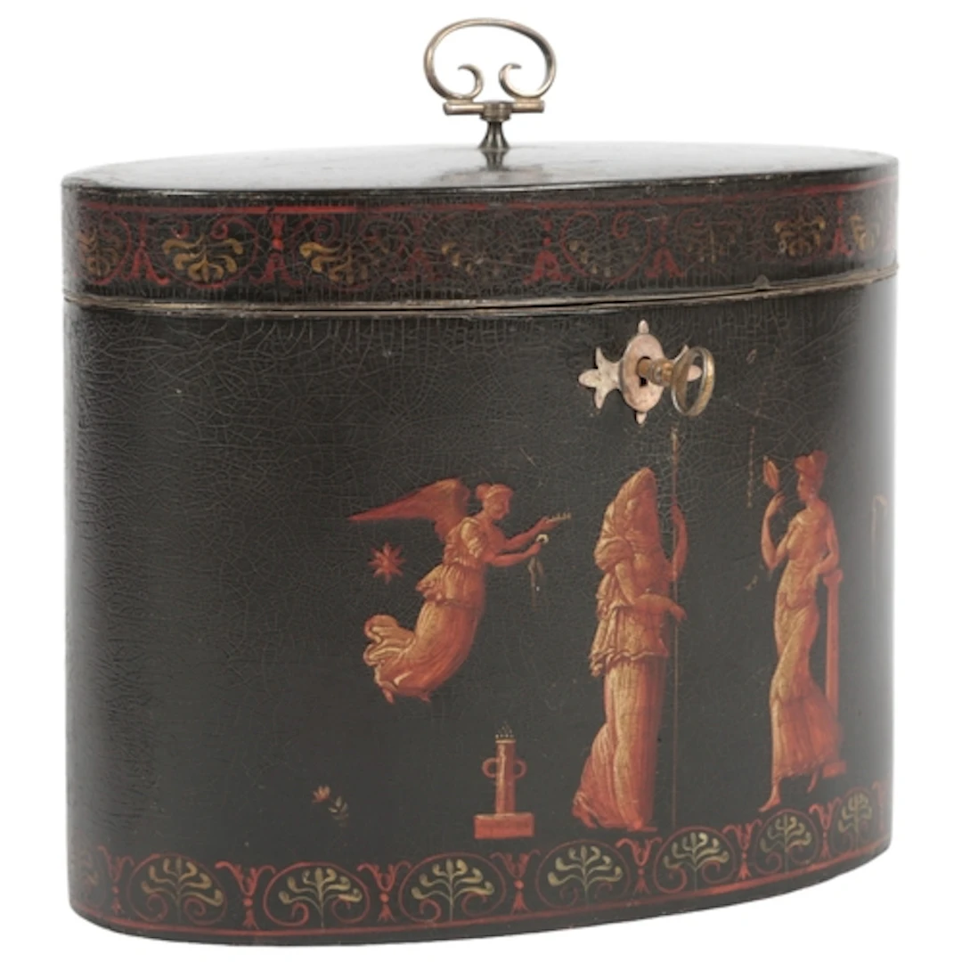 A George III Etruscan style black japanned oval tea caddy, a...