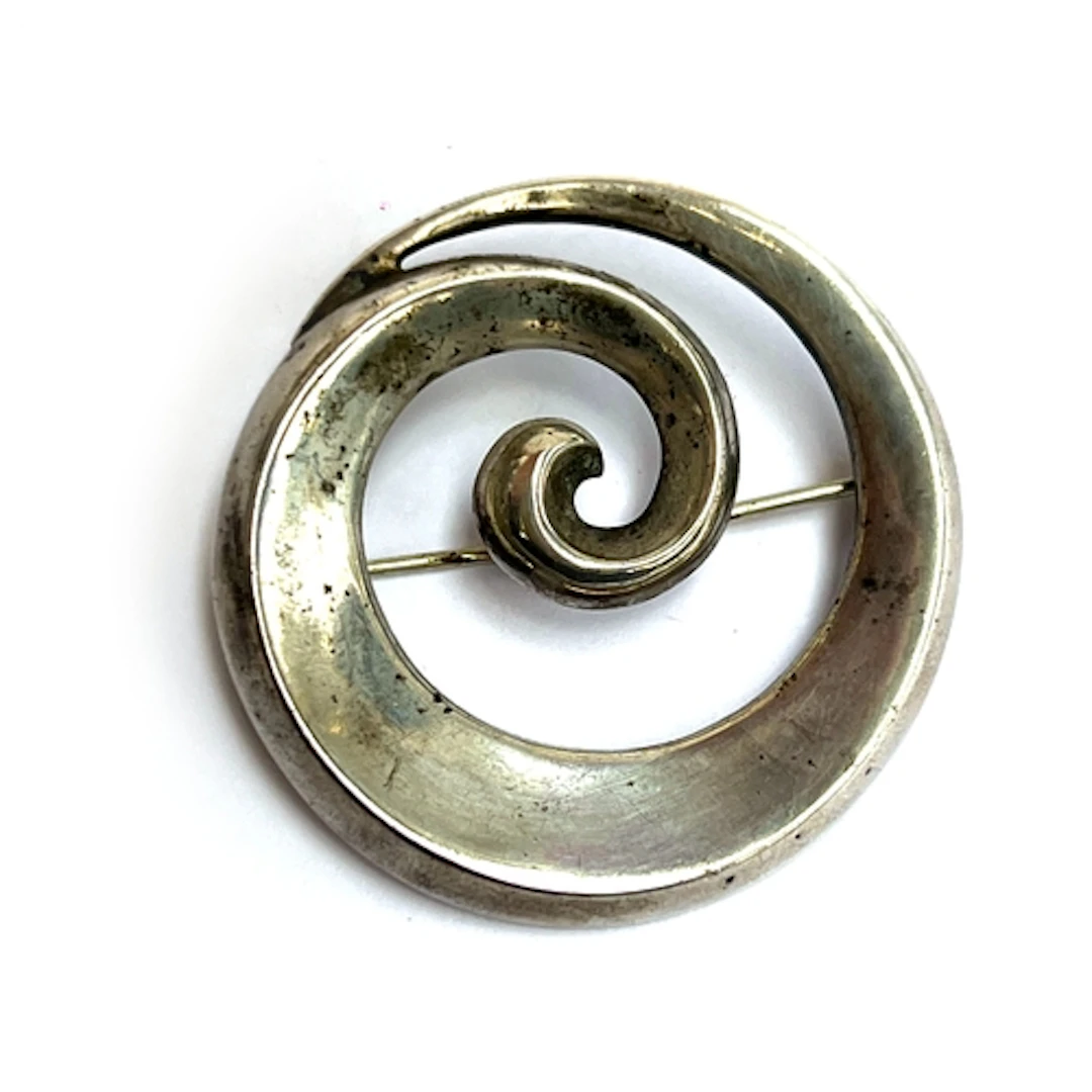 Just Andersen, a modernist silver swirl brooch, stamped 'Jus...