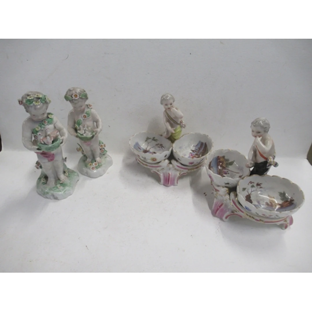A pair of Berlin porcelain table salts, modelled with putti ...