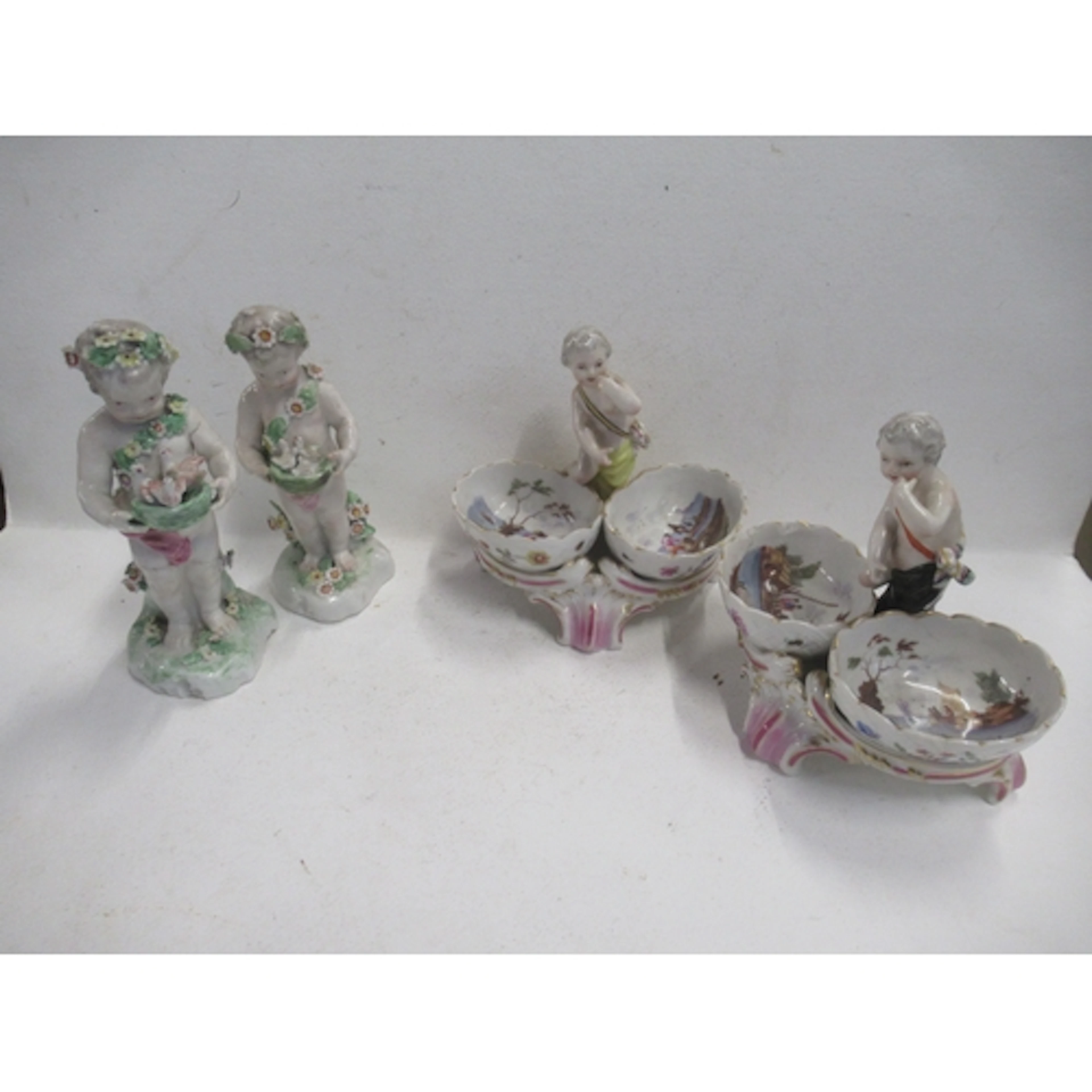 A pair of Berlin porcelain table salts, modelled with putti ...