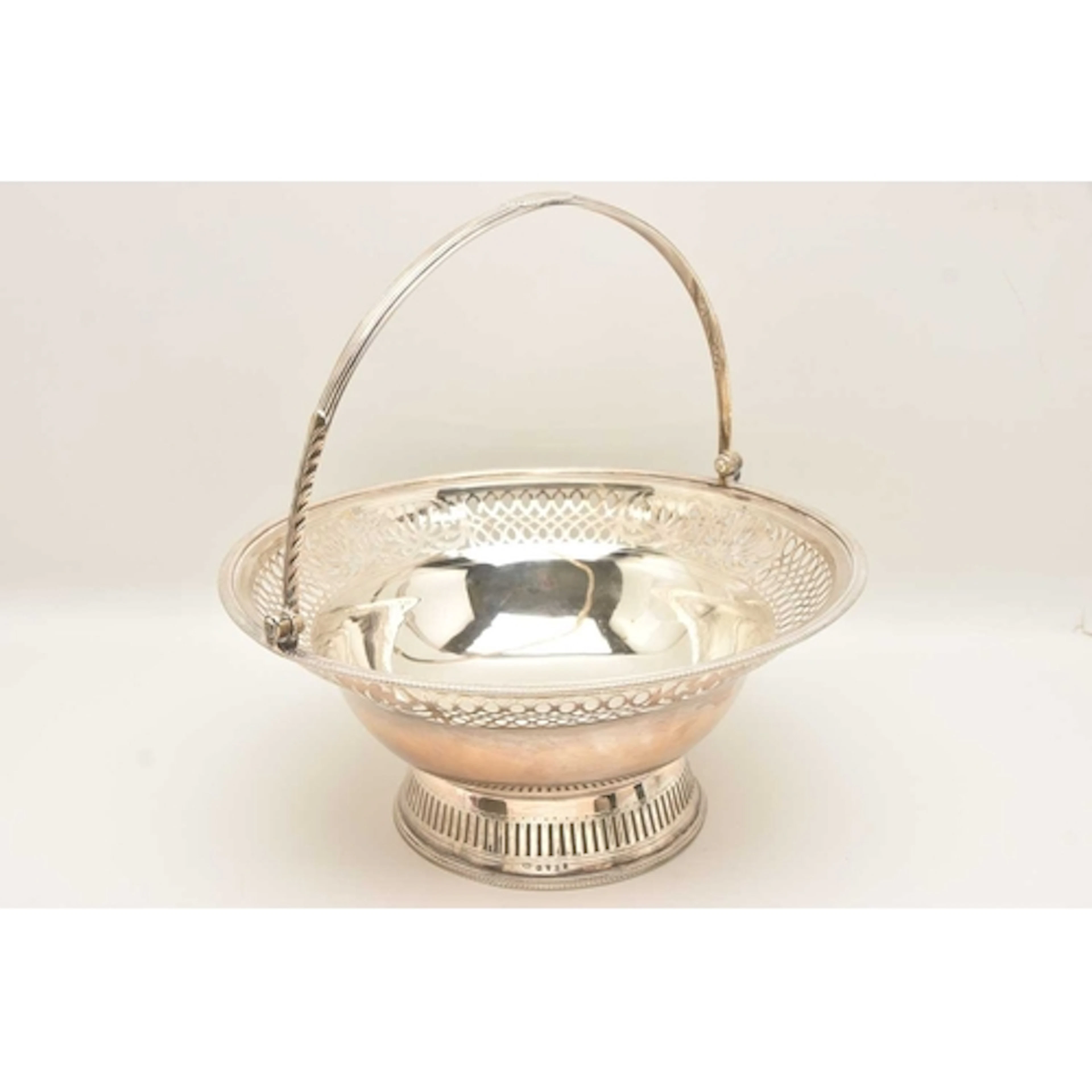 A GEORGE III SILVER BREAD BASKET, with pierced scrolling and...