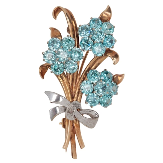 A zircon and diamond brooch, circa 1953, designed as a posy ...