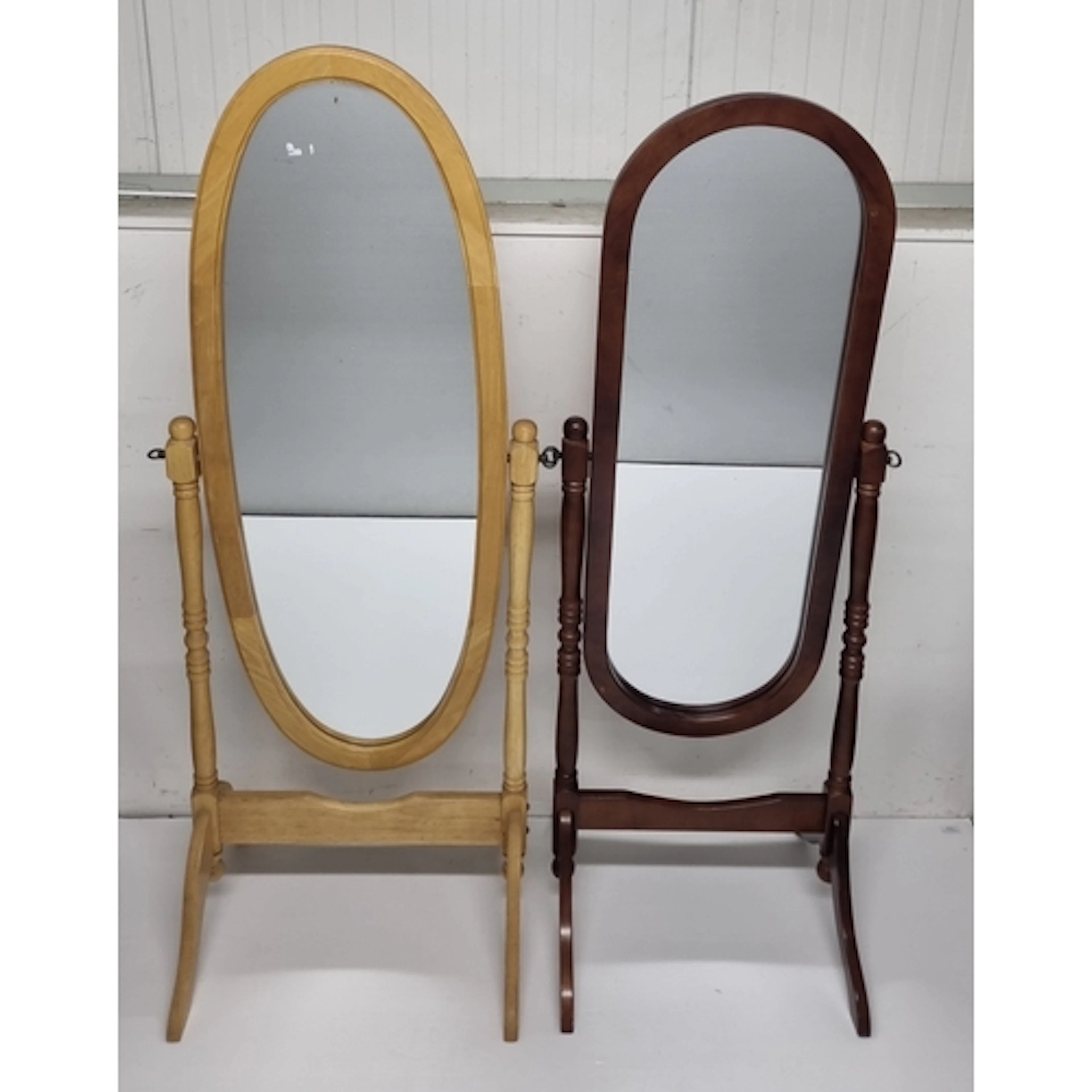 Pair of freestanding wooden cheval mirrors one in light woo...