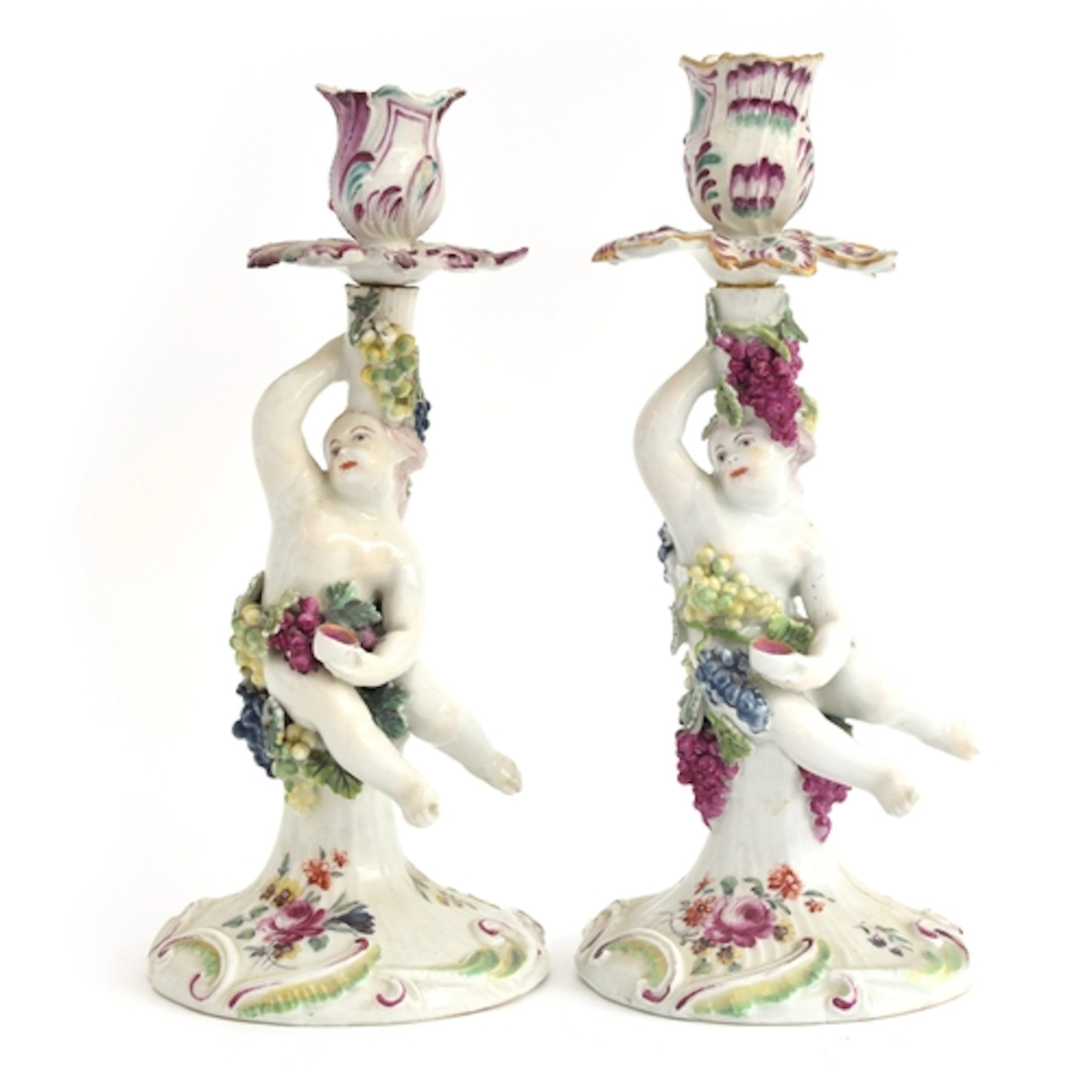 A pair of late 18th century Derby porcelain figural candlest...