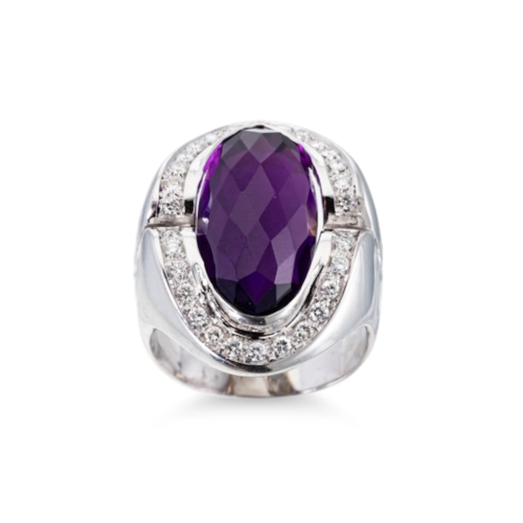 AN AMETHYST AND DIAMOND CLUSTER RING, the oval mixed cut ame...