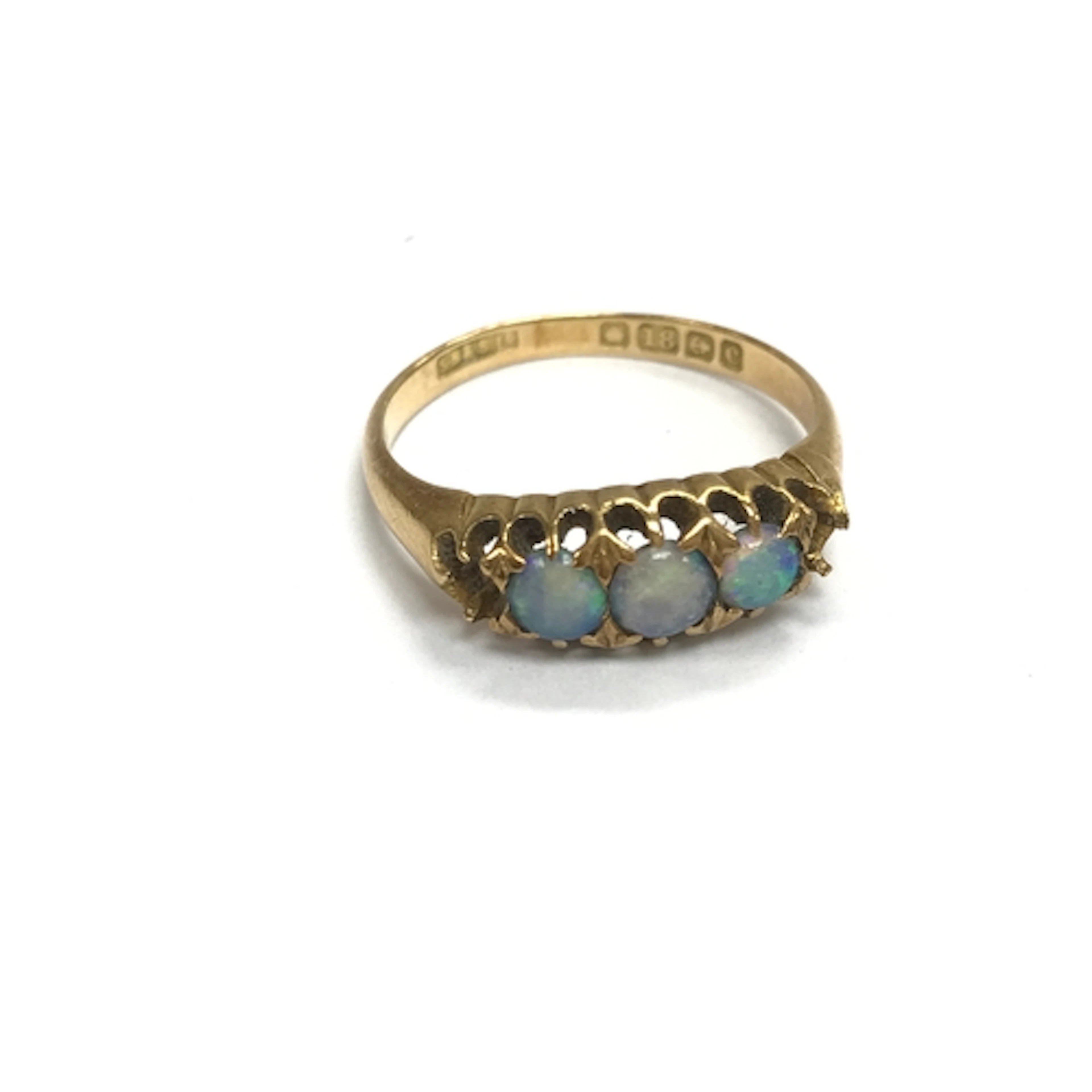 An 18ct gold ring set with opals (two stones missing). p 1/2...