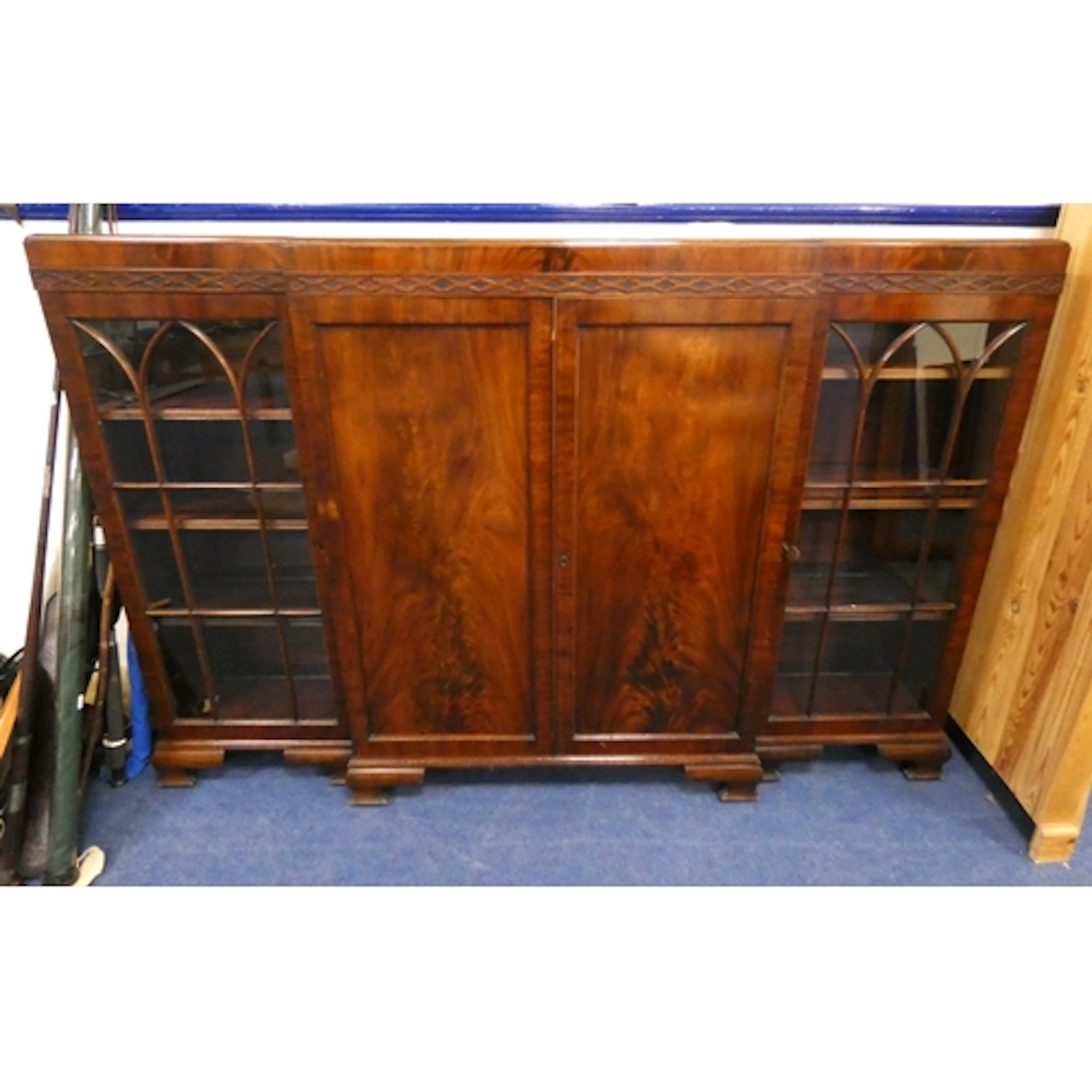 Mahogany breakfront bookcase with two panel doors flanked by...