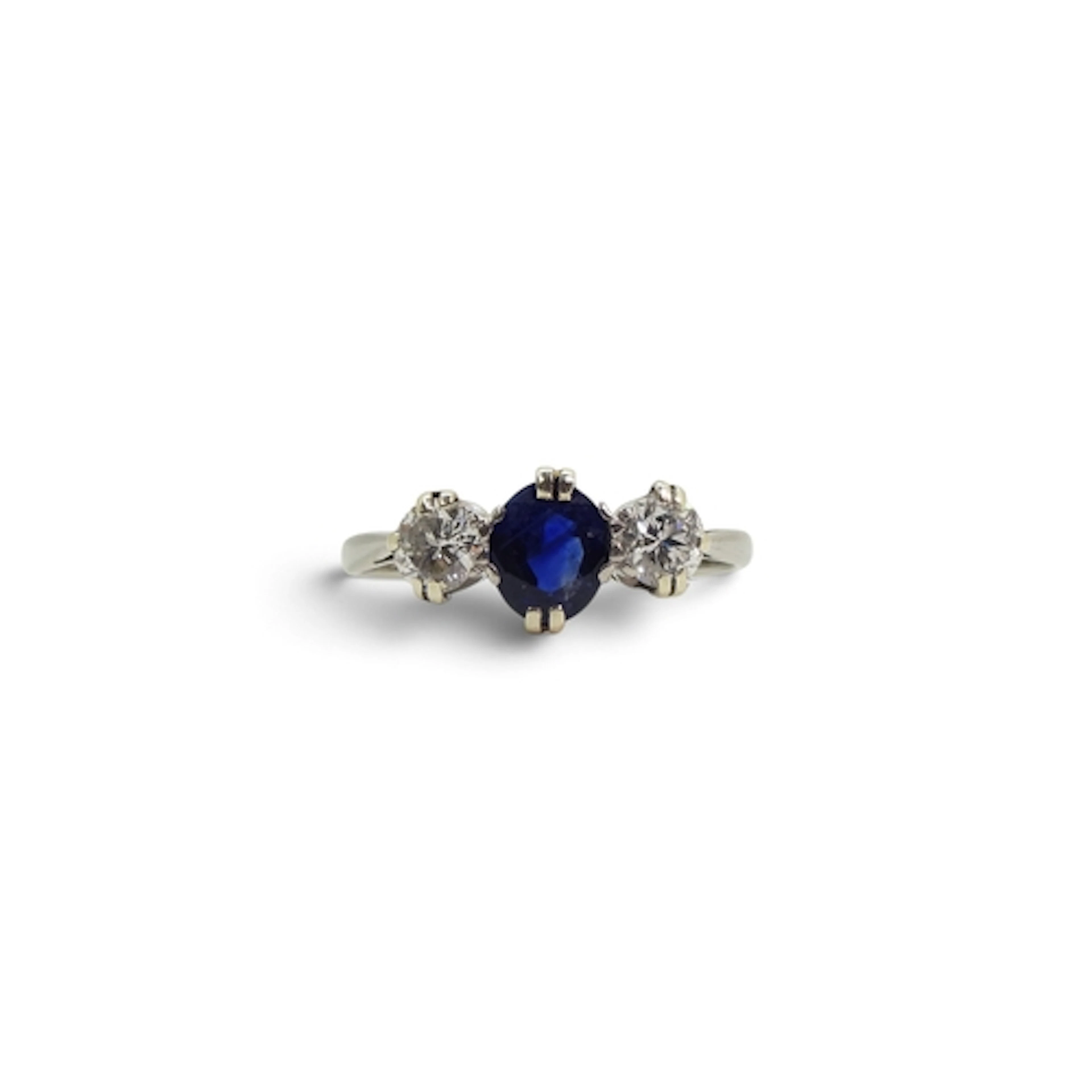 A platinum sapphire and diamond three stone ring, the classi...