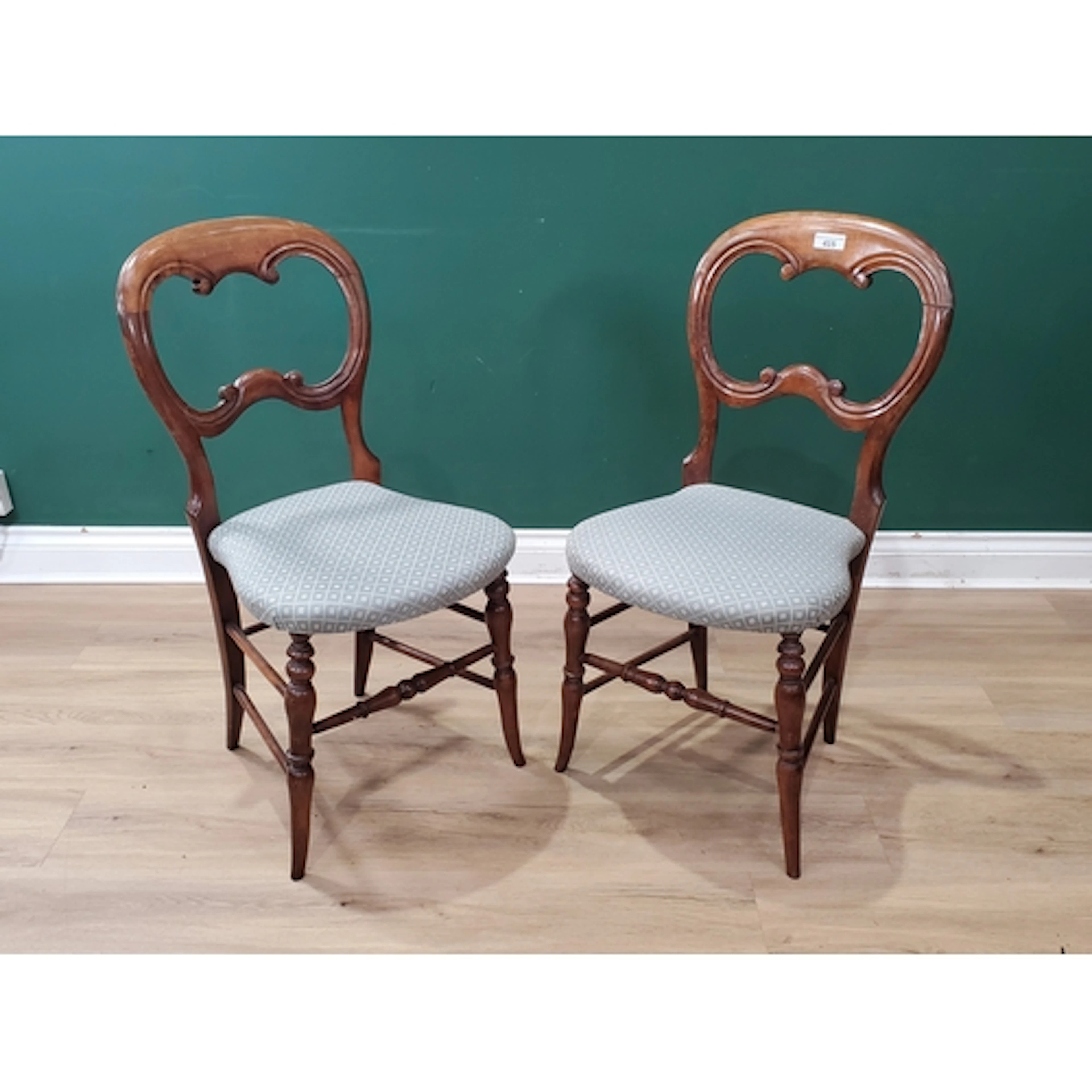A pair of Victorian walnut Salon Chairs with balloon backs, ...