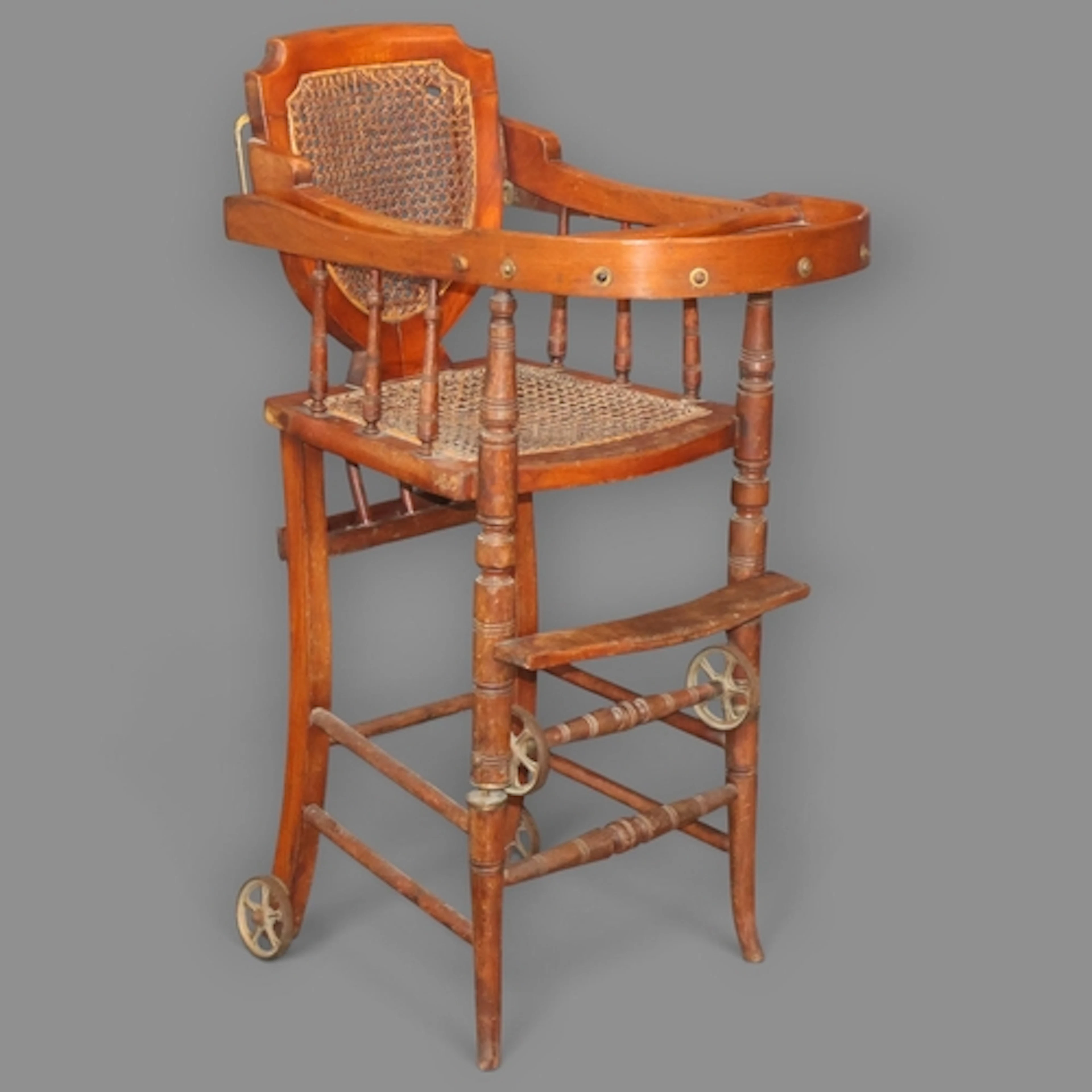 An antique mahogany cane seated metamorphic child's high cha...