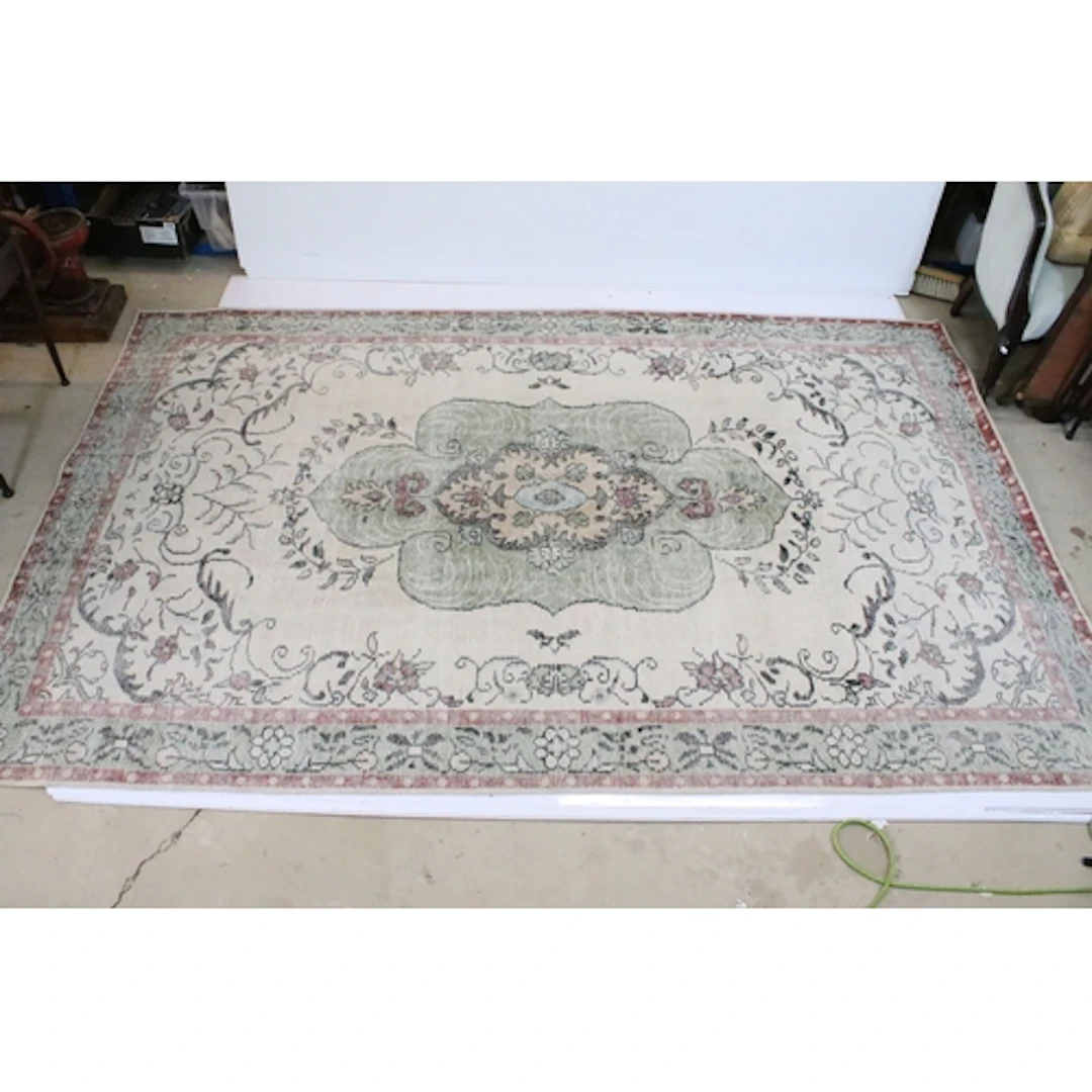 Oka cream ground rug, with central medallion within borders,...