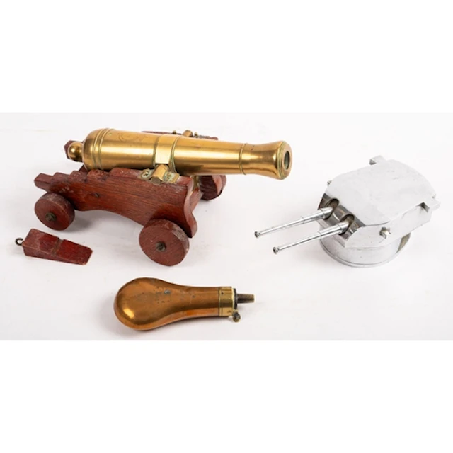 A 20th Century brass desk cannon. Mounted on wooden carriage...