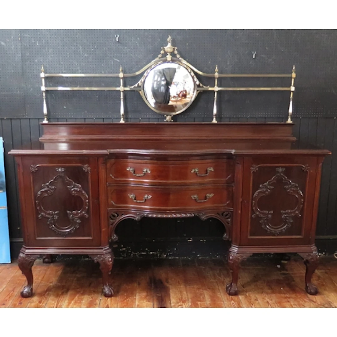 A large mahogany breakfront sideboard, the arched anodised b...