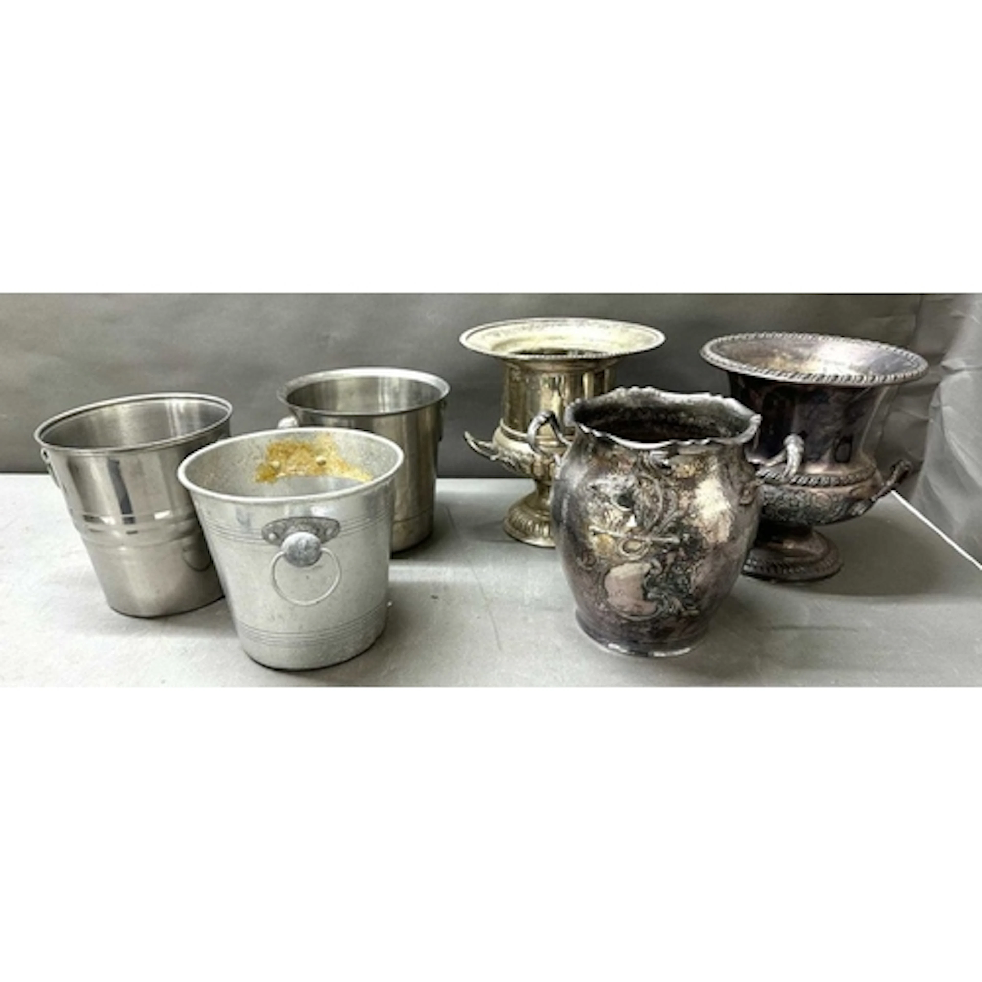A trio of champagne buckets with a varirty of patterns with ...