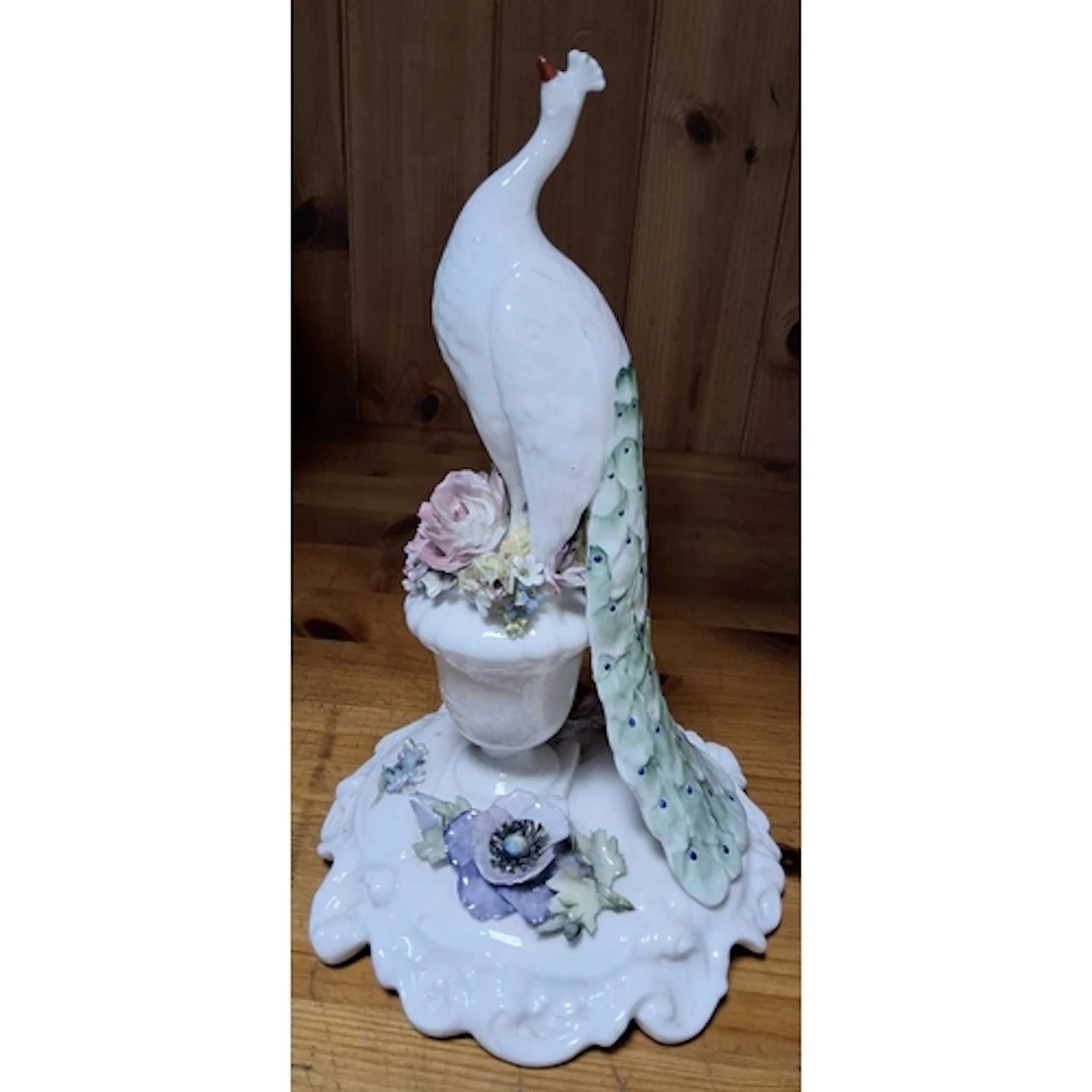 A ROYAL CROWN DERBY PEACOCK FIGURE, the peacock figure stand...