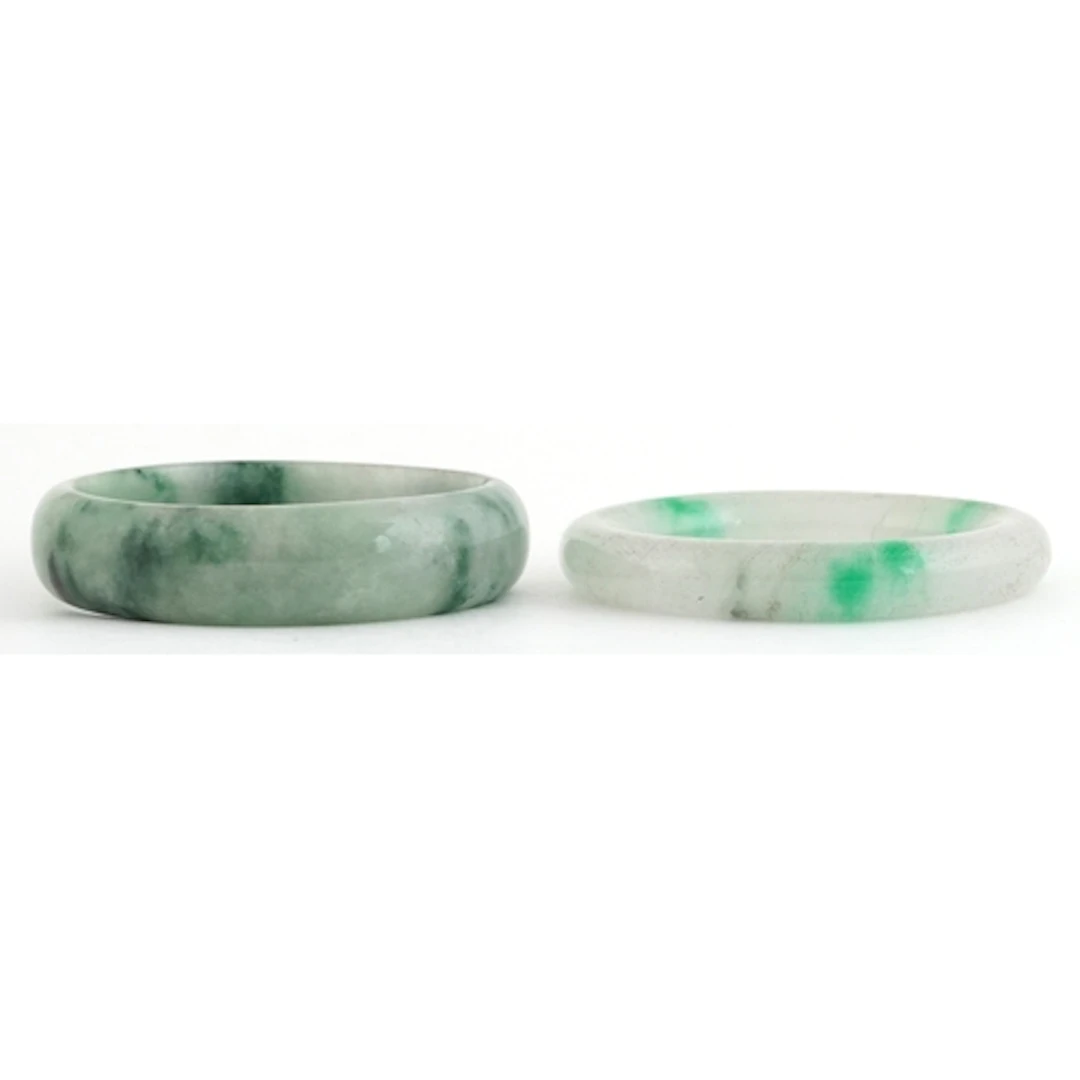 Two Chinese green stone bangles, each 6.7cm in diameter, tot...