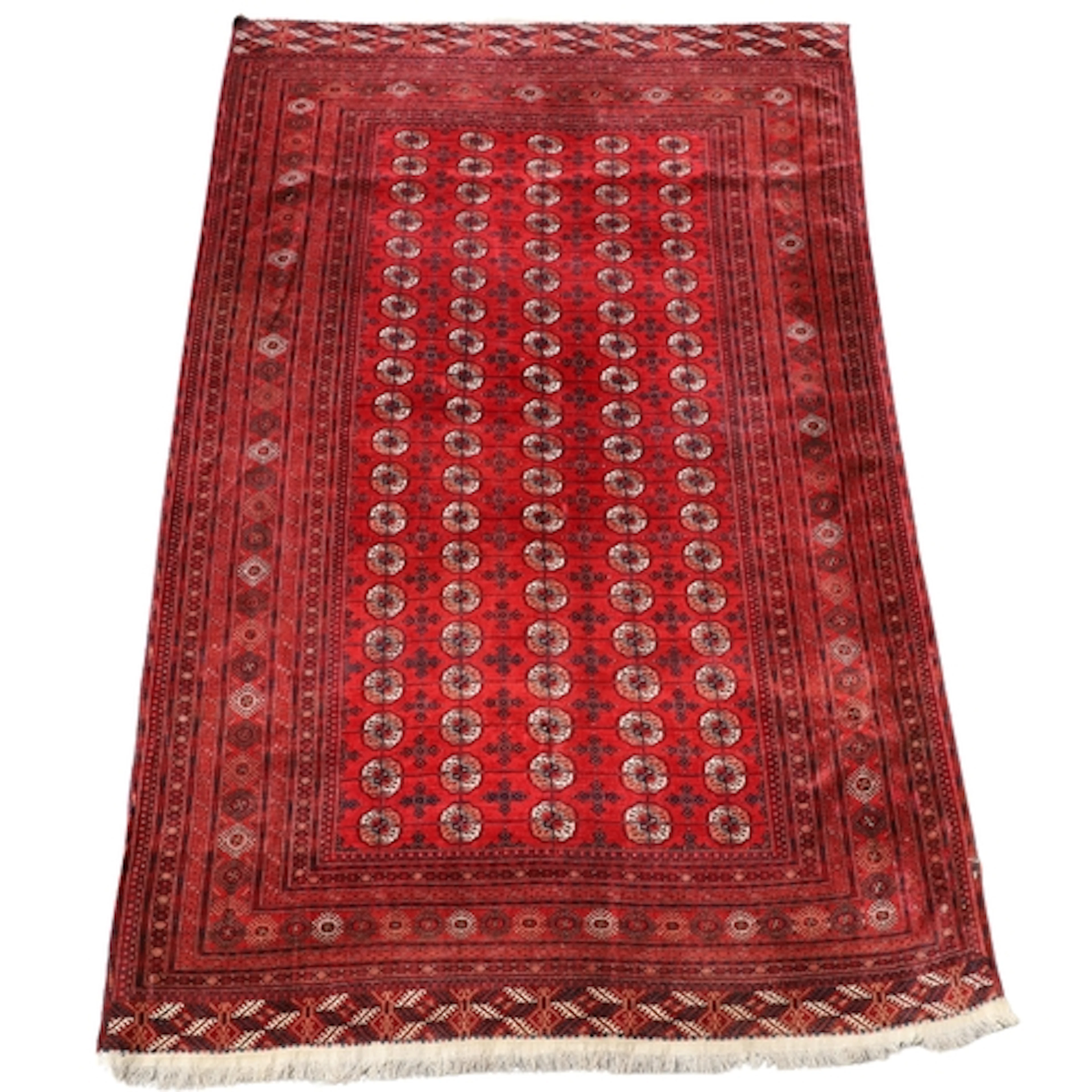 A TEKKE TURKMEN CARPET. The deep terracotta field with five ...