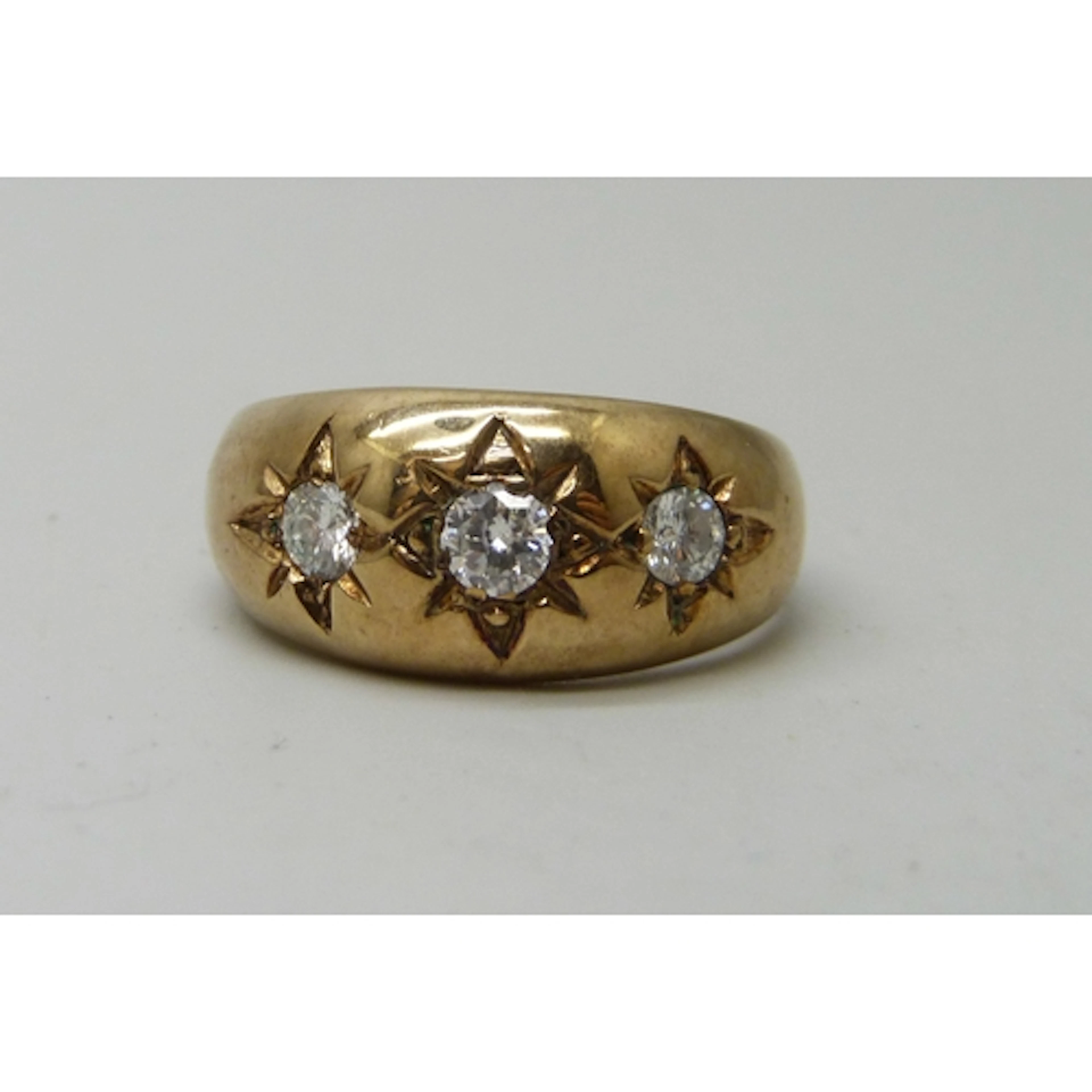 A 9ct gold Victorian style gypsy ring set with three diamond...