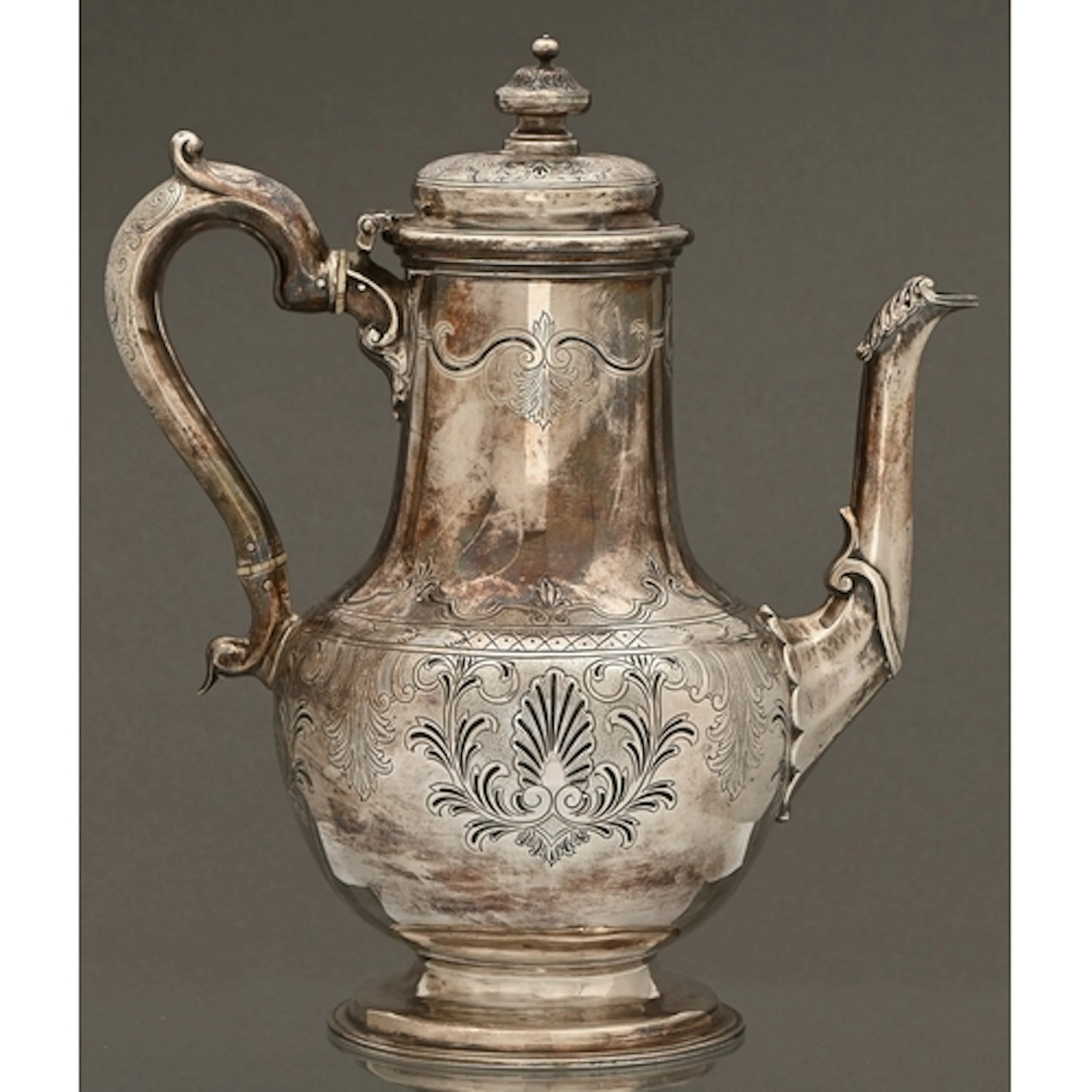 A Victorian silver coffee pot, chased with palmettes within ...