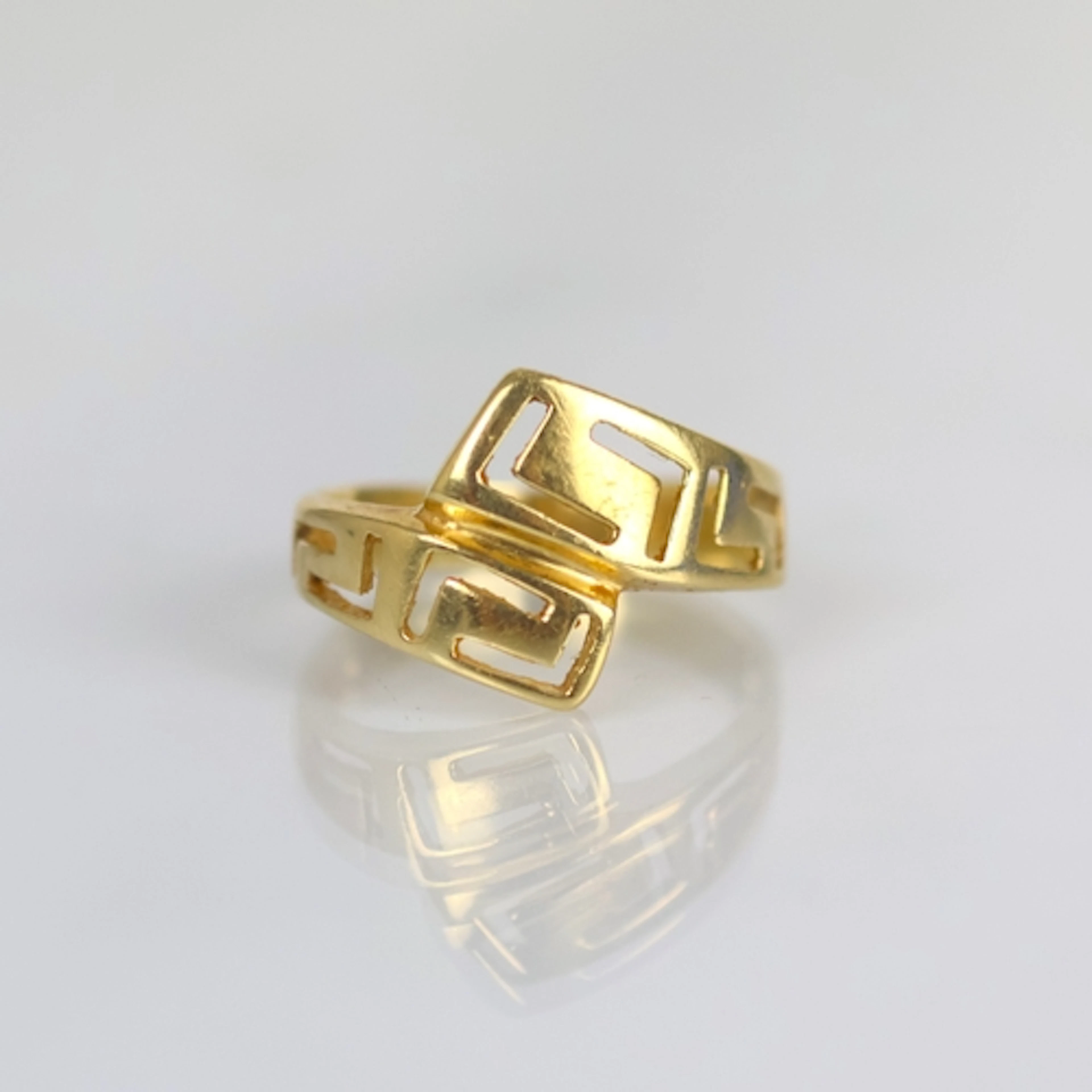 A contemporary yellow metal dress ring, the openwork twist d...