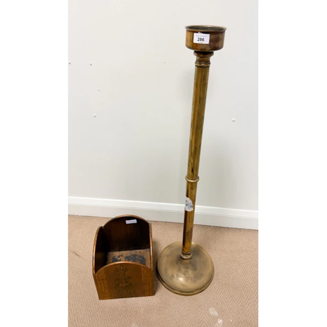A floor standing brass ecclesiastical candle stick and a woo...