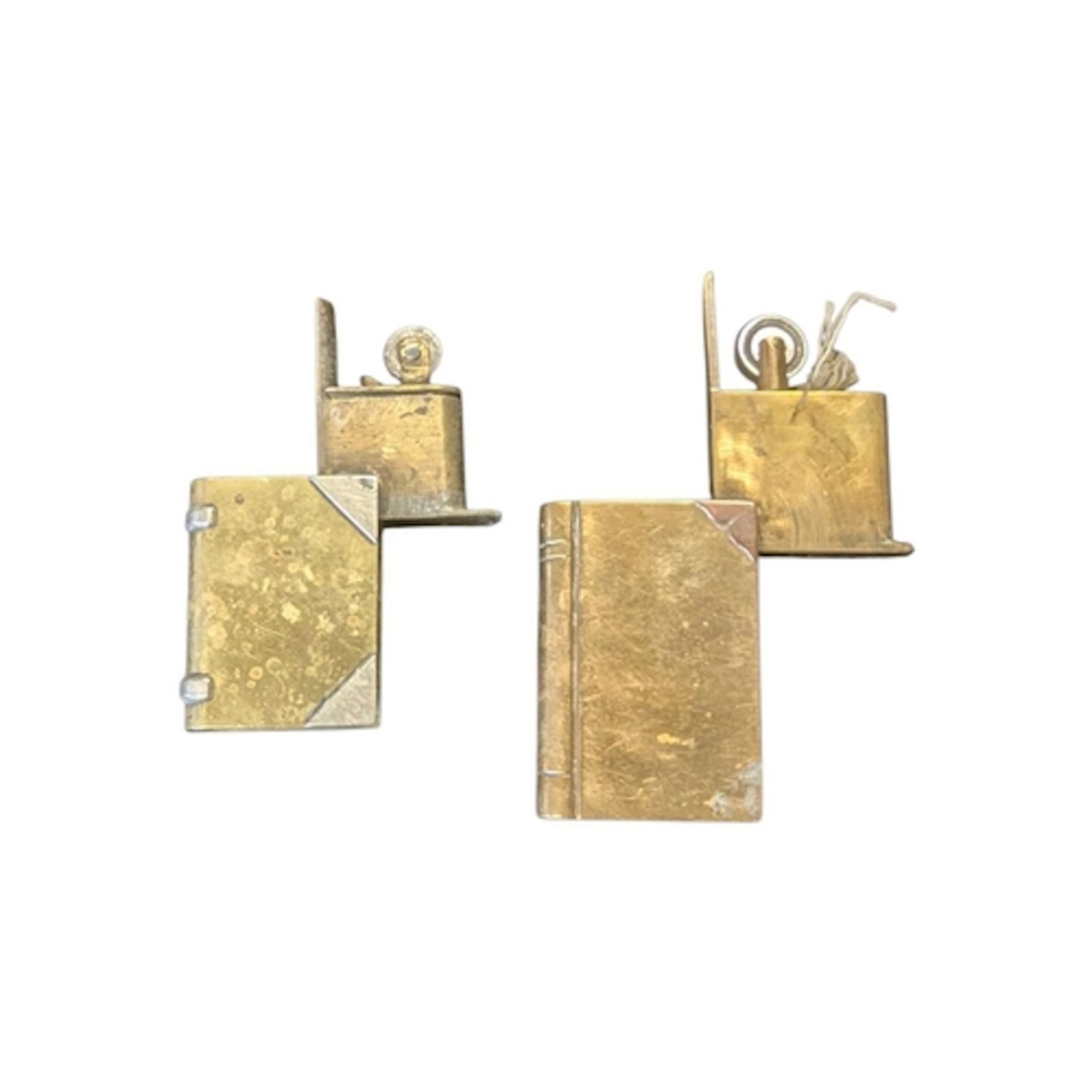 Two vintage 20th century brass book lighters. Each featuring...