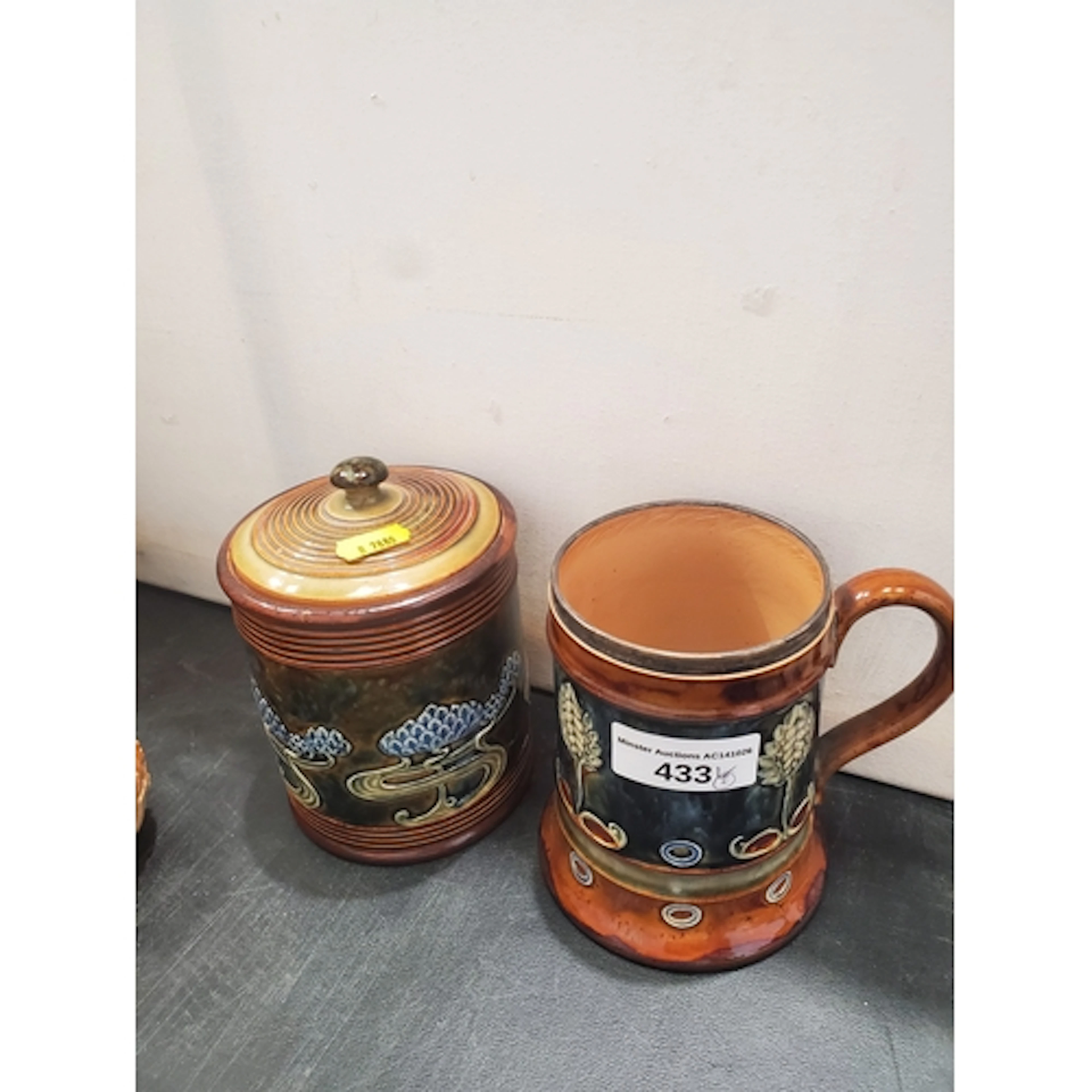 A Royal Doulton blue glazed Tankard and a lidded Pot by Emil...