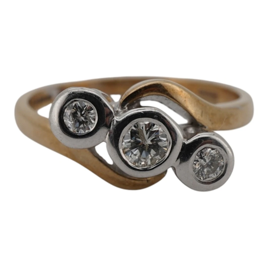 A three-stone diamond ring, set with three brilliant-cut dia...