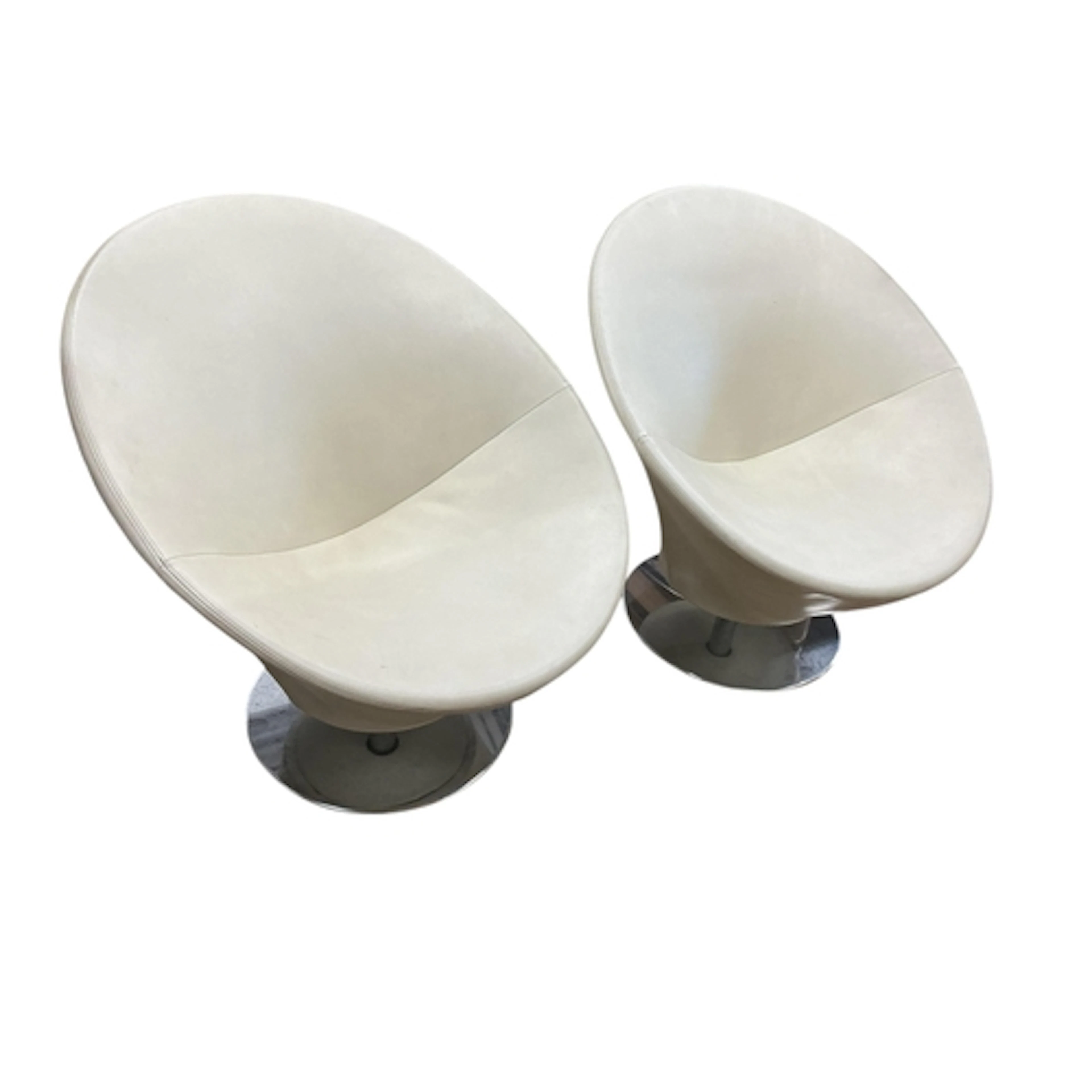 A pair of contemporary circular frame swivel lounge chairs o...