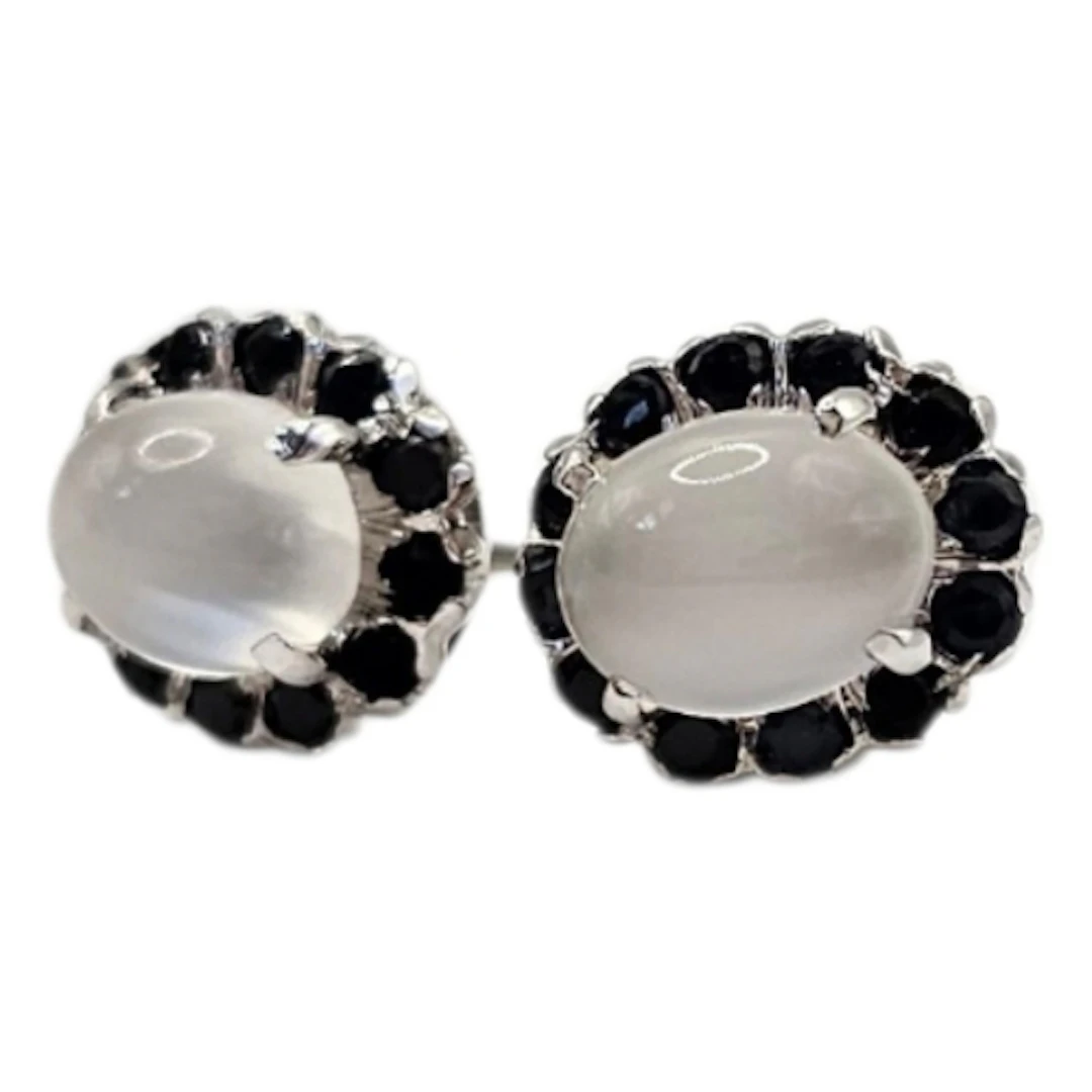 A PAIR OF MOONSTONE AND SAPPHIRE STUD EARRINGS Central oval ...
