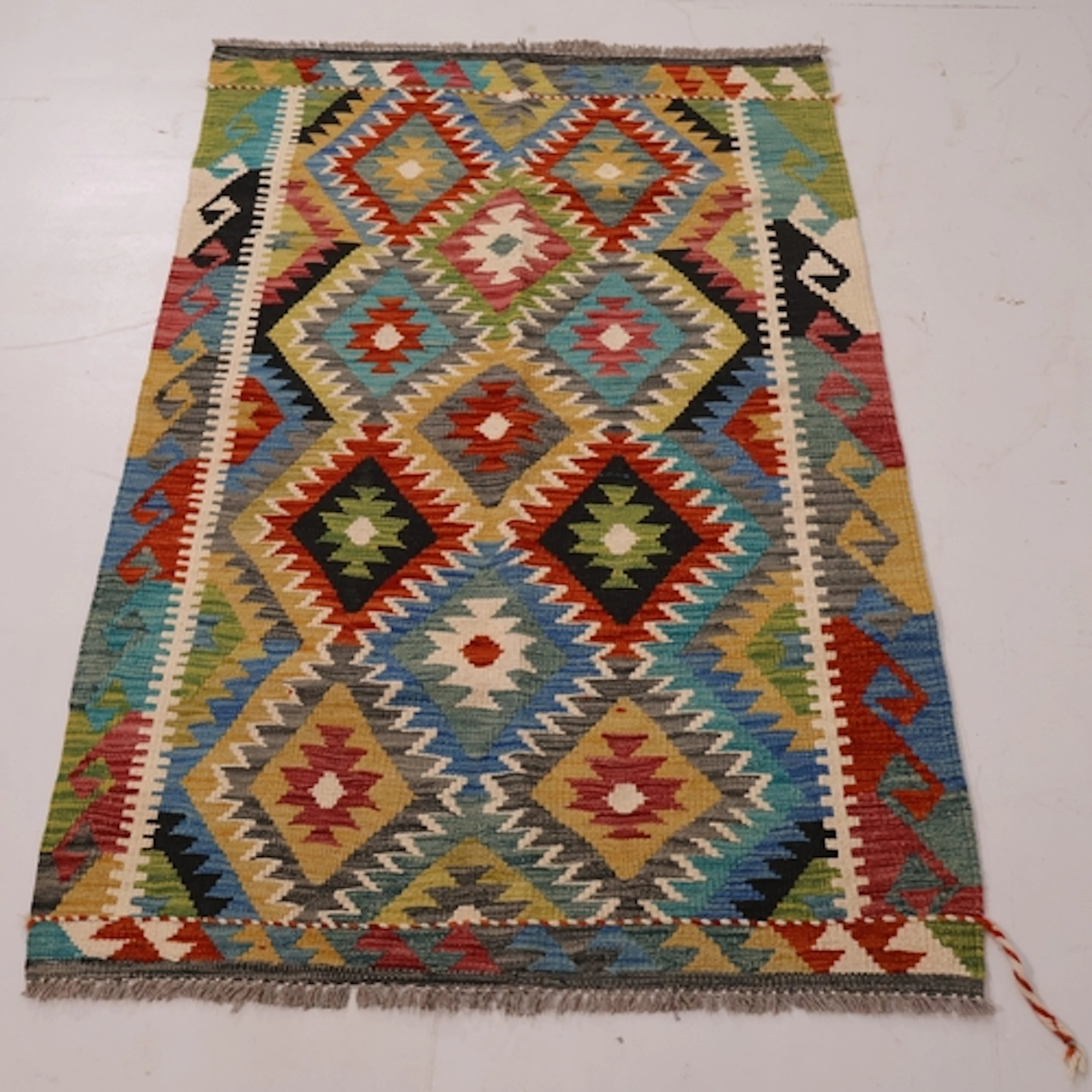 A green ground chobi kilim rug, with geometric design, L150c...