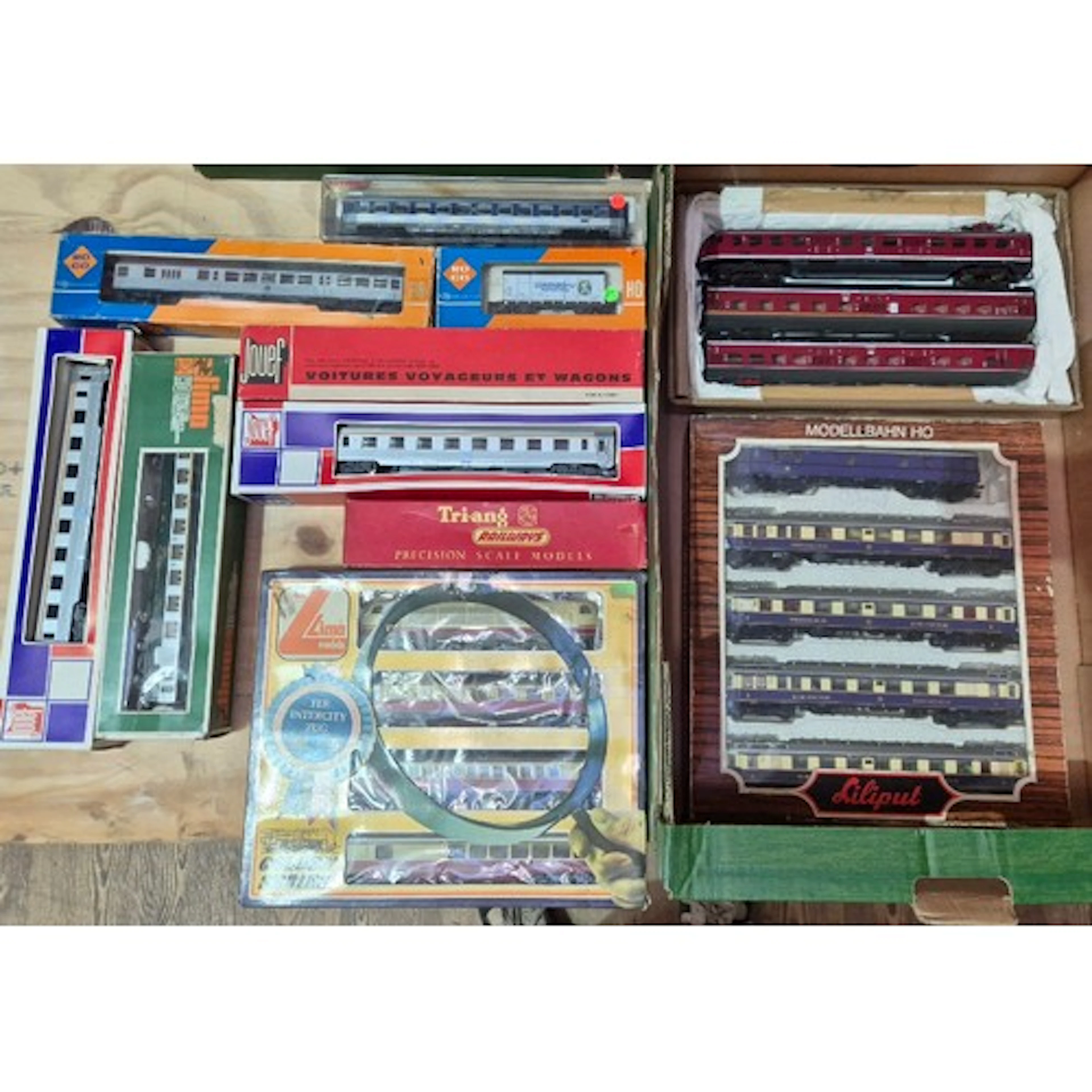 A box of assorted model train coaches to include Jouef, Roco...