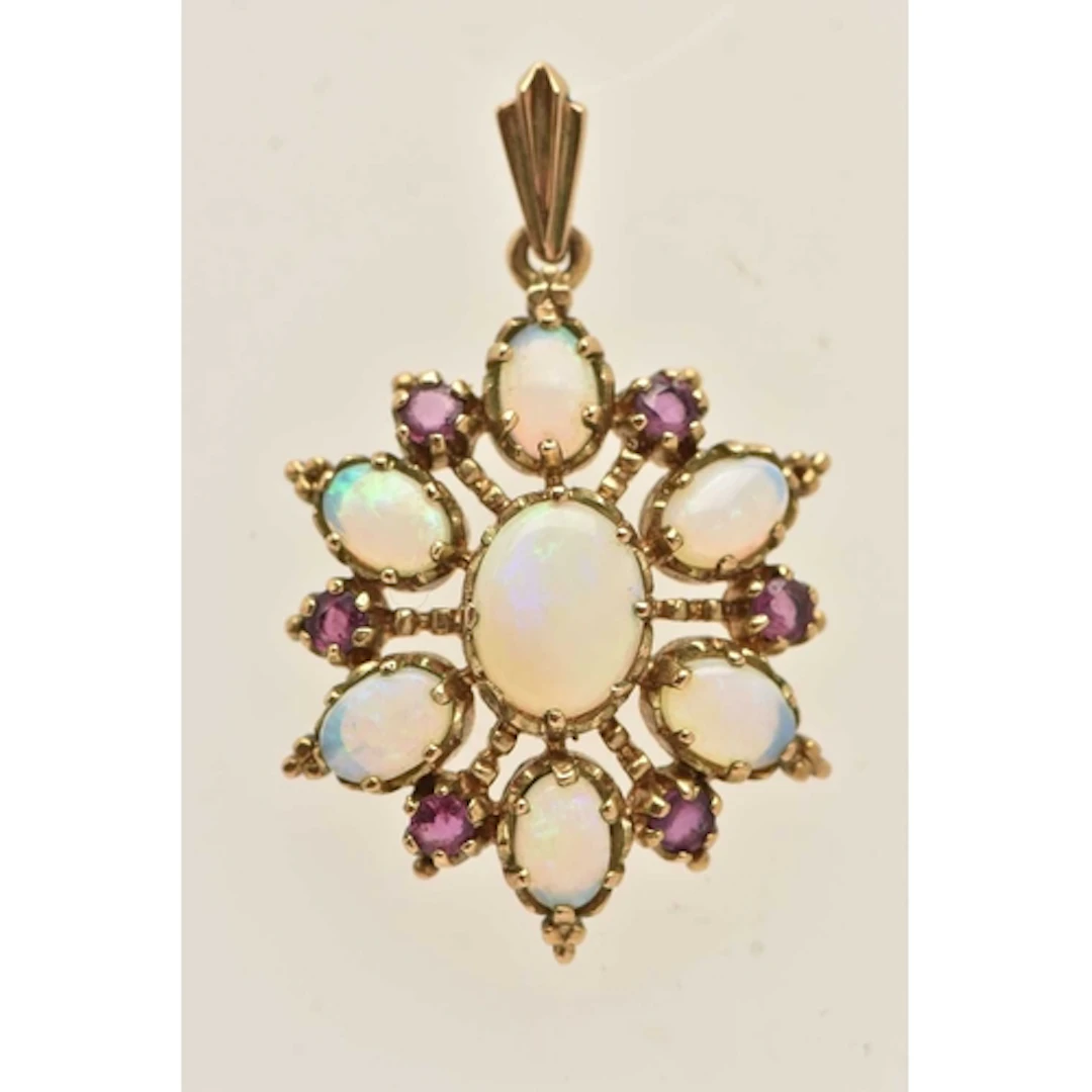 A 9CT YELLOW GOLD GEM SET PENDANT, a floral cluster set with...