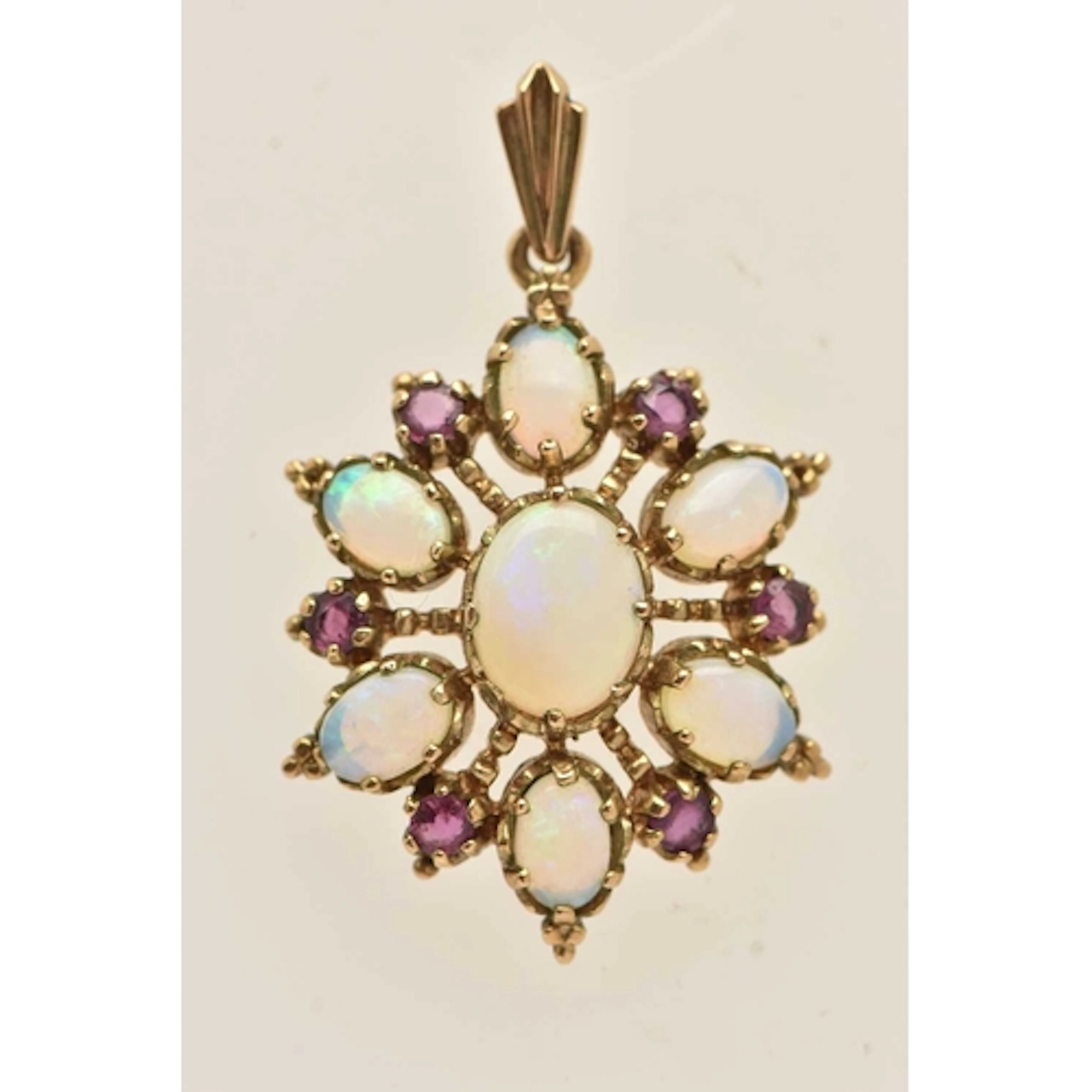 A 9CT YELLOW GOLD GEM SET PENDANT, a floral cluster set with...