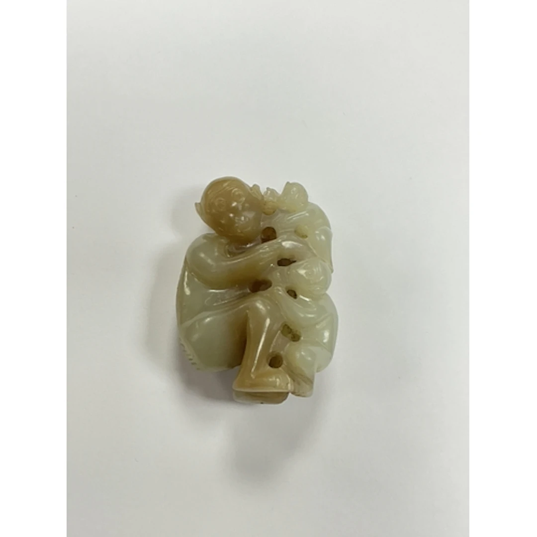 A Chinese pale celadon and brown jade monkey group, length 5...