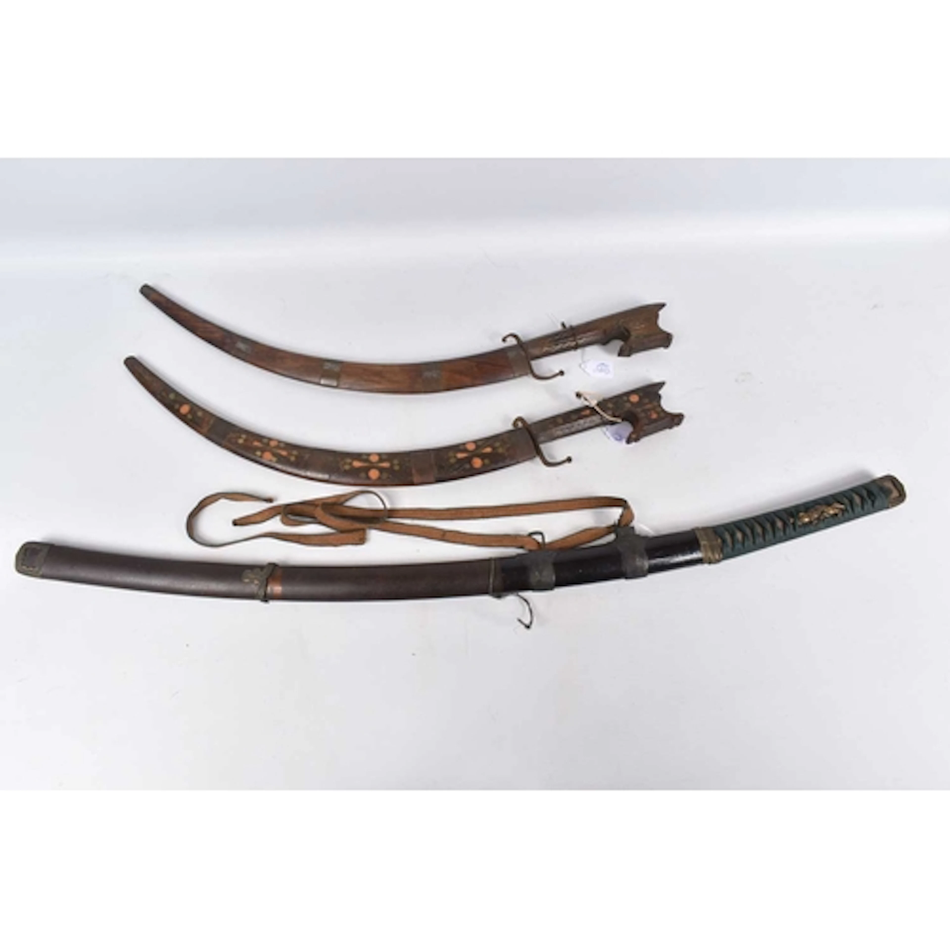 A MODERN SAMURAI SWORD AND TWO VINTAGE AFRICAN SWORDS, the S...