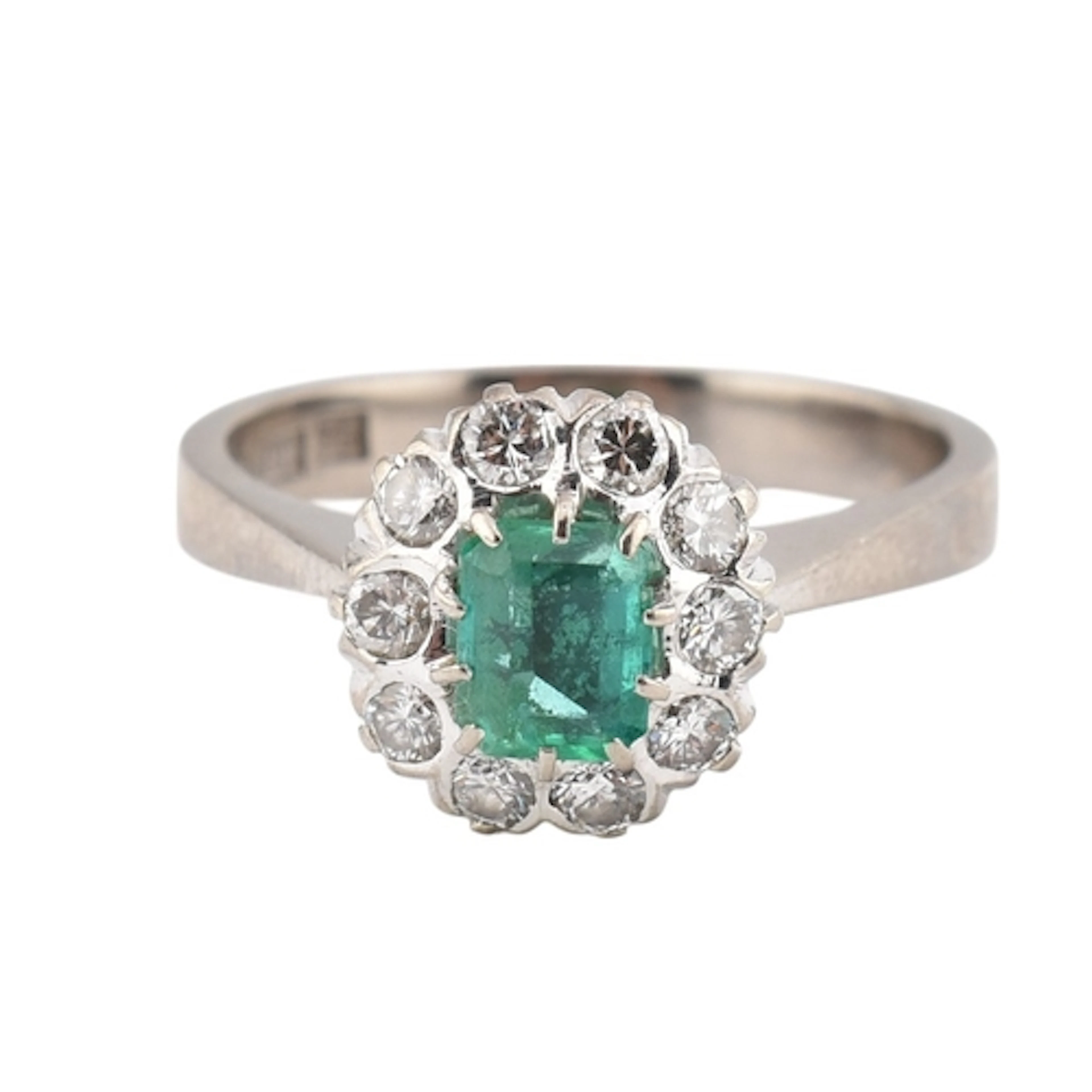 An 18ct white gold emerald and diamond ring. The ring having...
