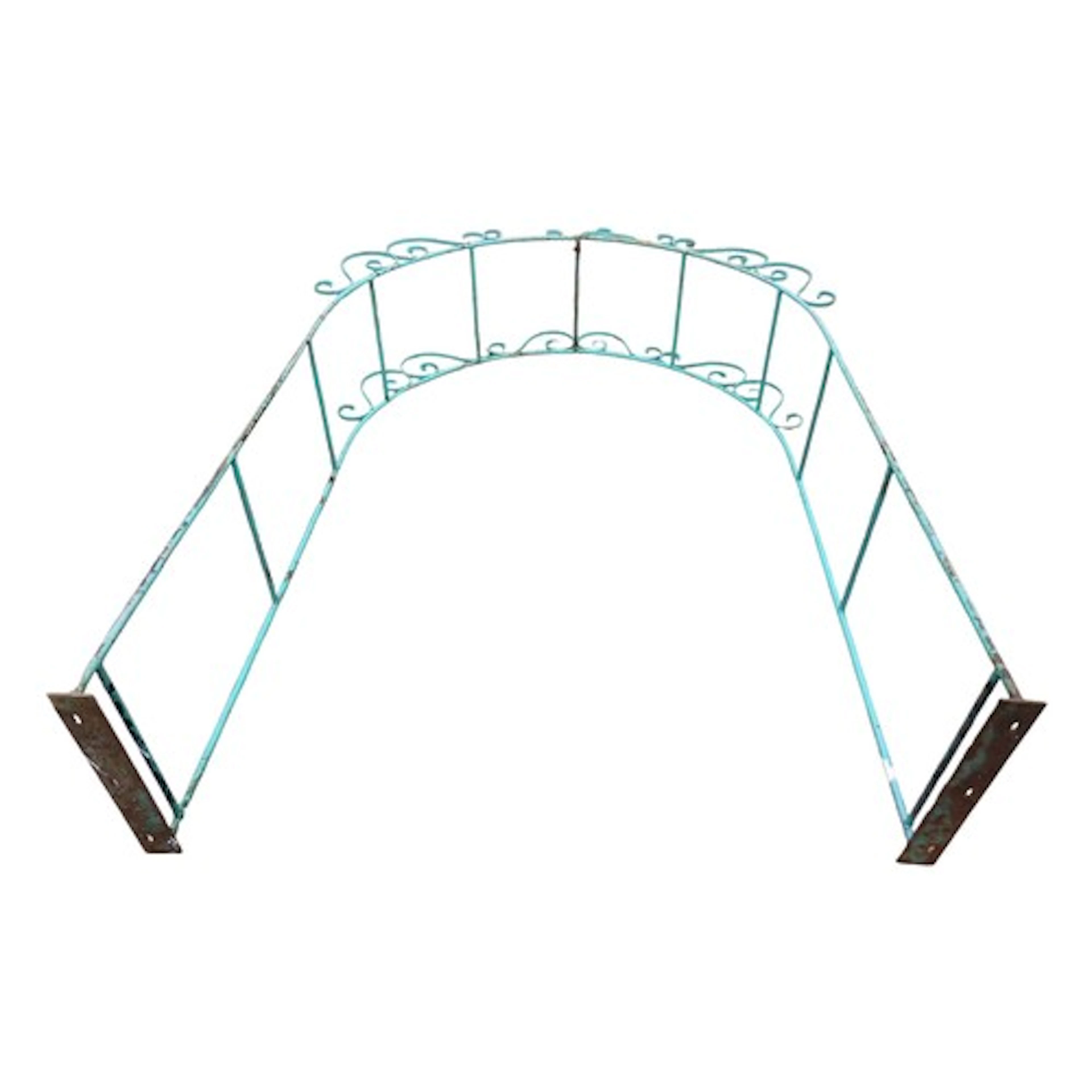 A weathered green painted ironwork two sectional arbour with...