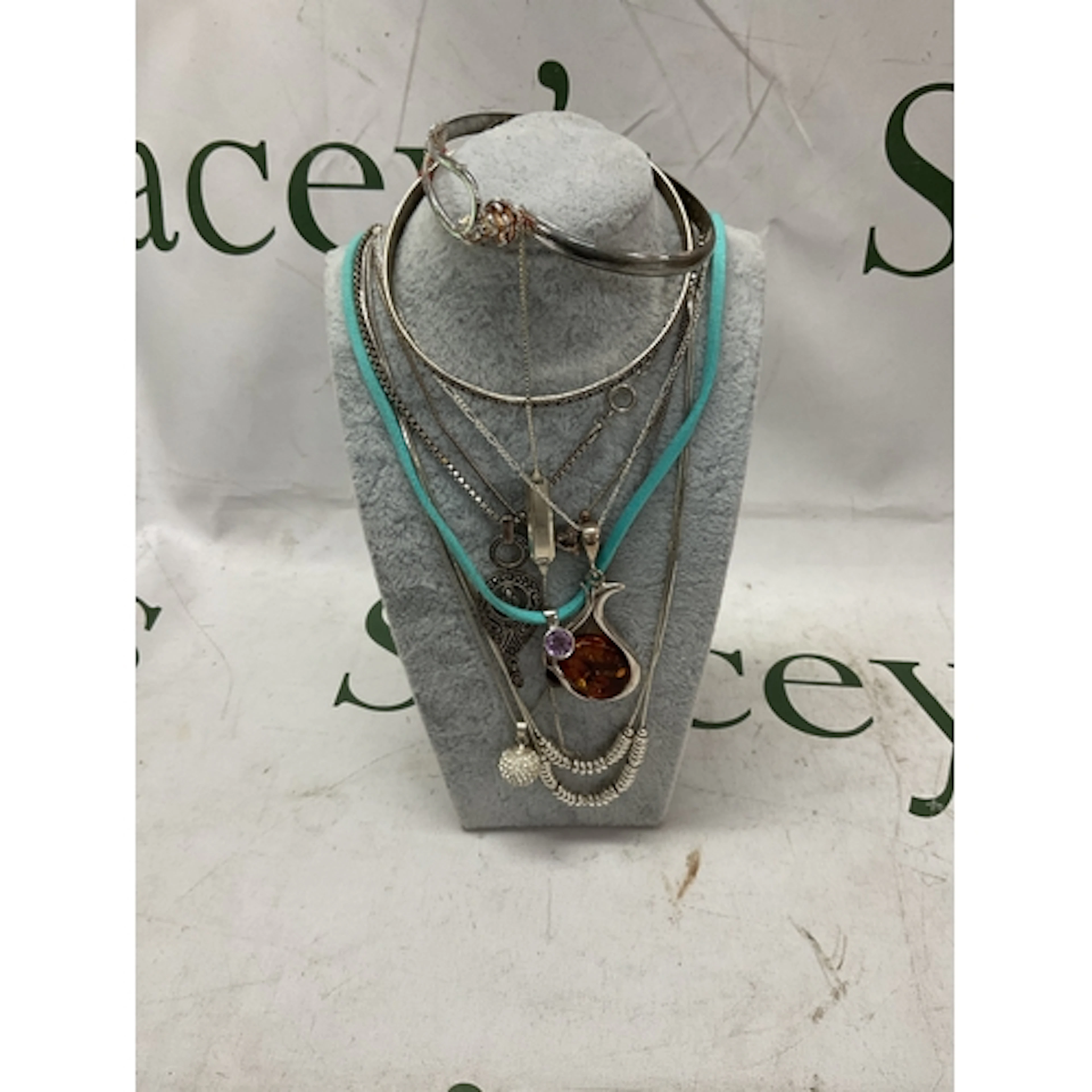 Silver dress necklaces and pendants and bracelets.