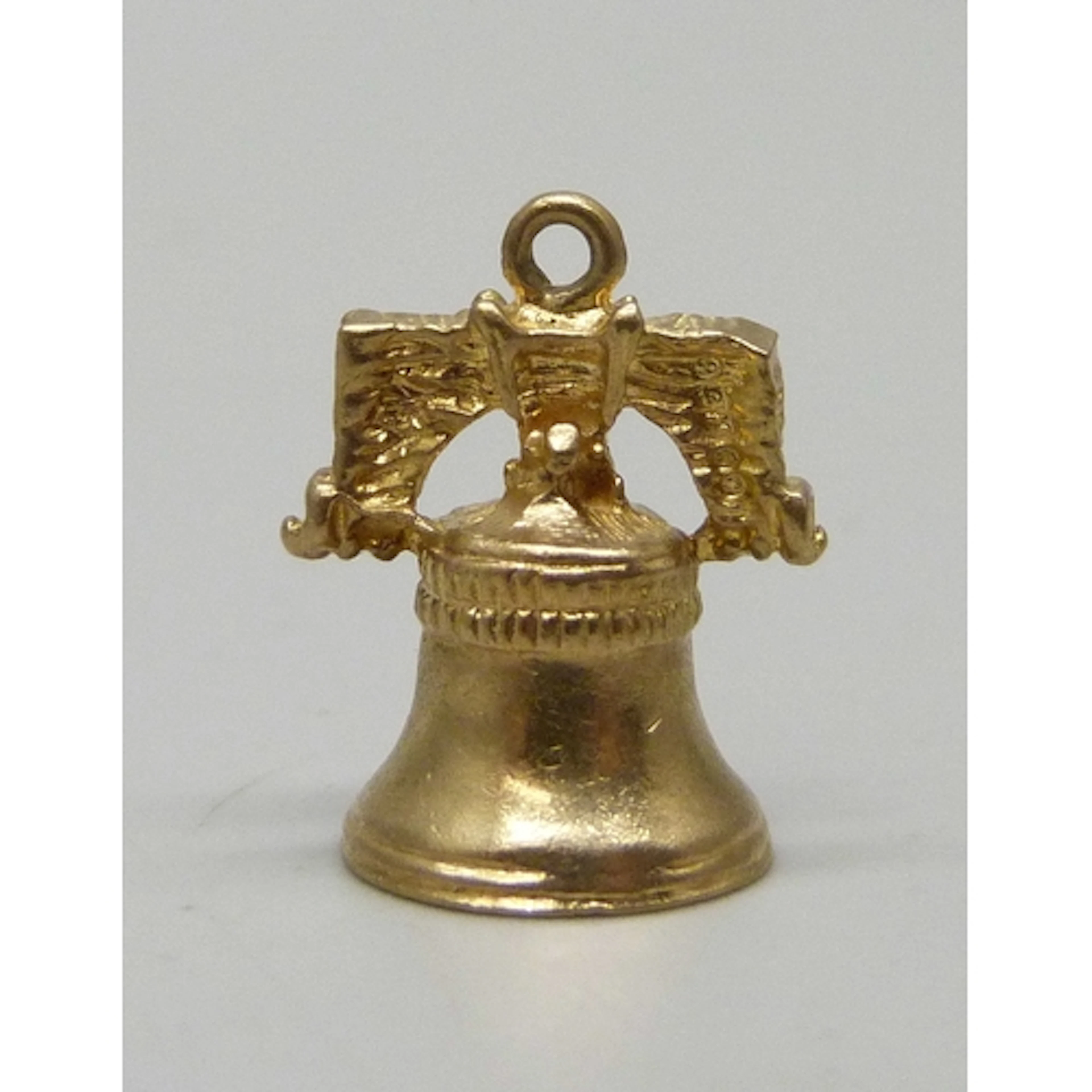 A 9ct gold charm in the form of a bell, hallmarked, 2.7g, 1....