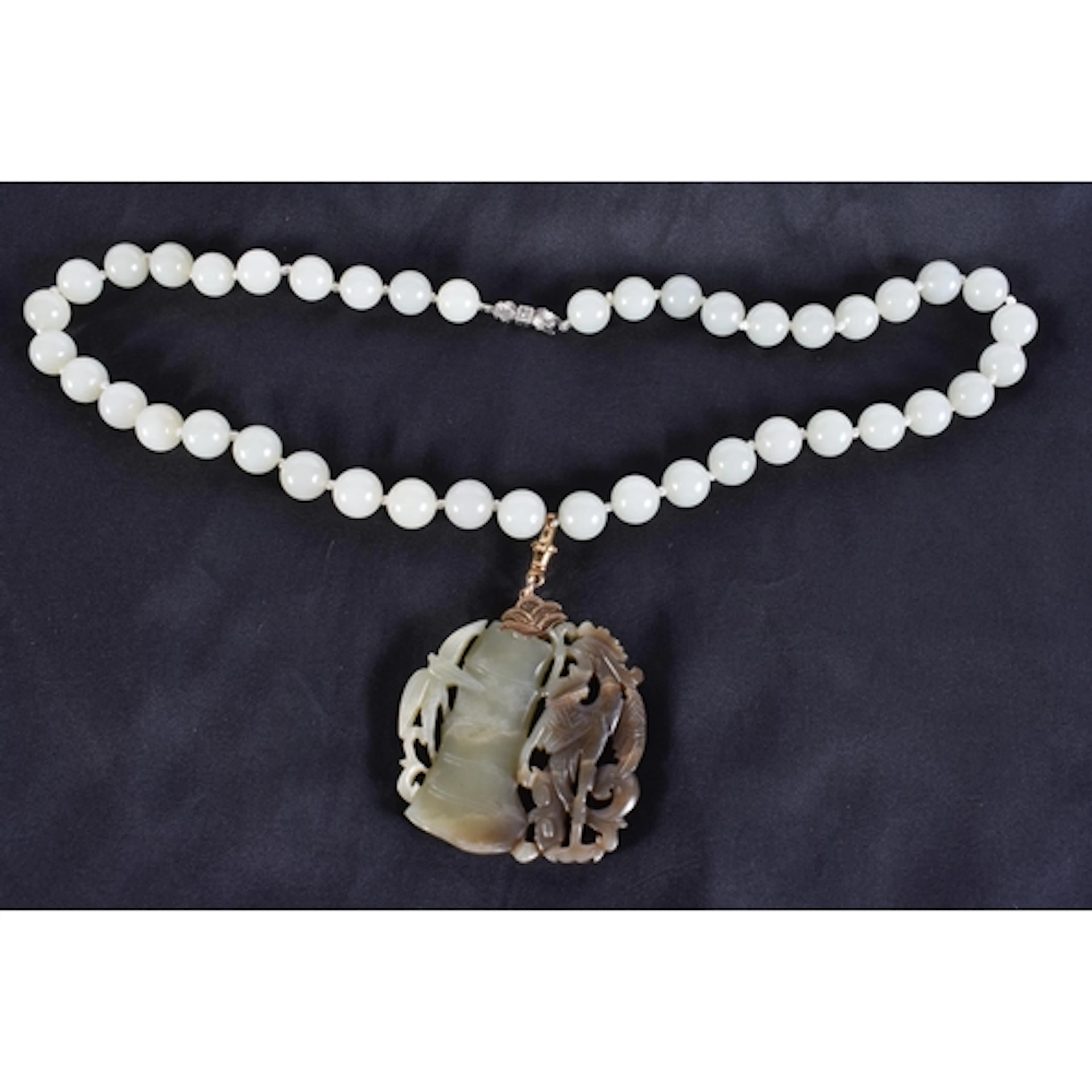 A CHINESE QING DYNASTY JADE NECKLACE. 66 cm long, pendant 5....